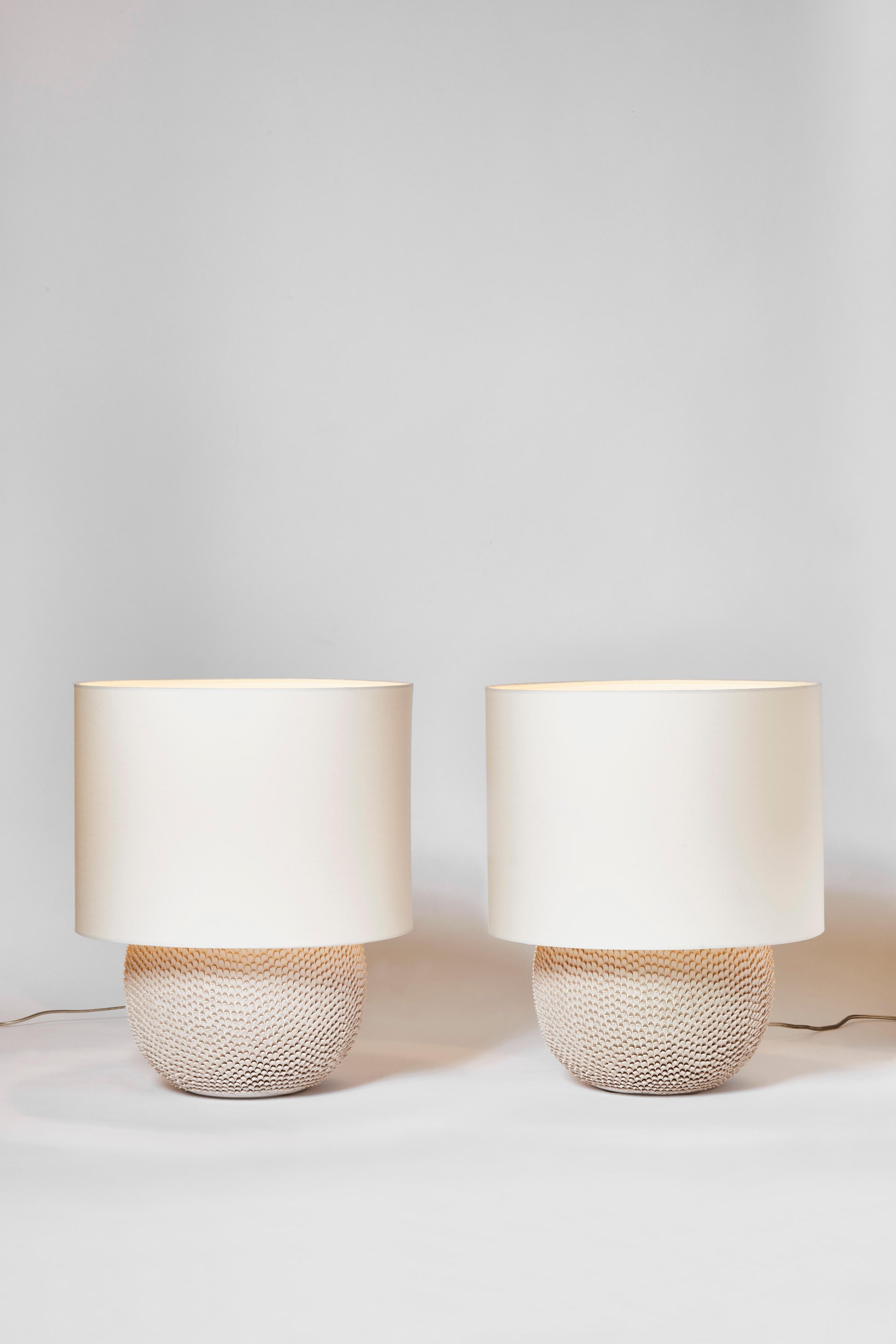 Pair of beautiful French modern table lamps made of natural color ceramic.
The whole surface of the lamps are hand-pinched to create this impression of scales or feathers.