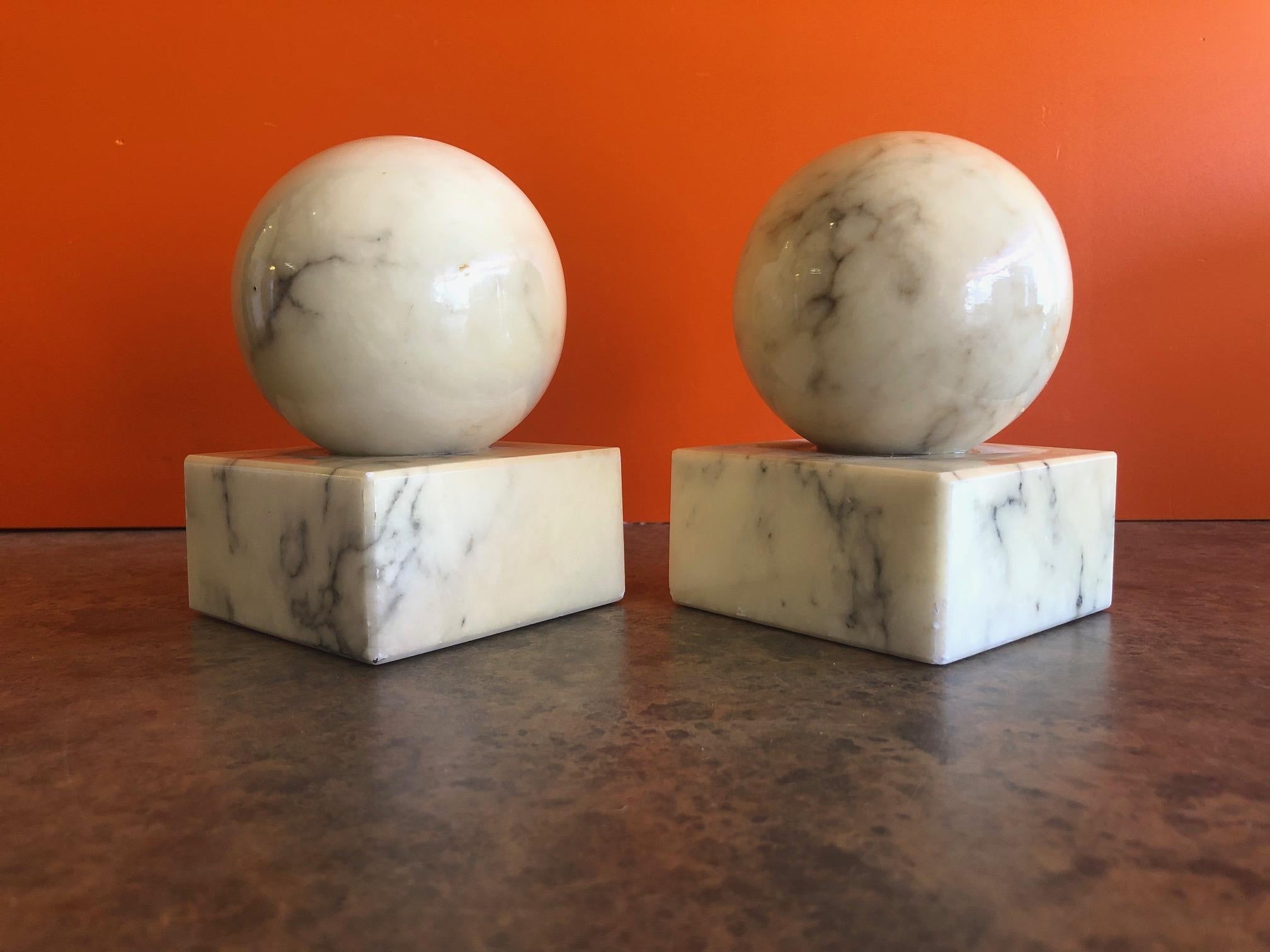 Nice pair of round modernist solid marble bookends in white, circa 1970s. The pair has a 3