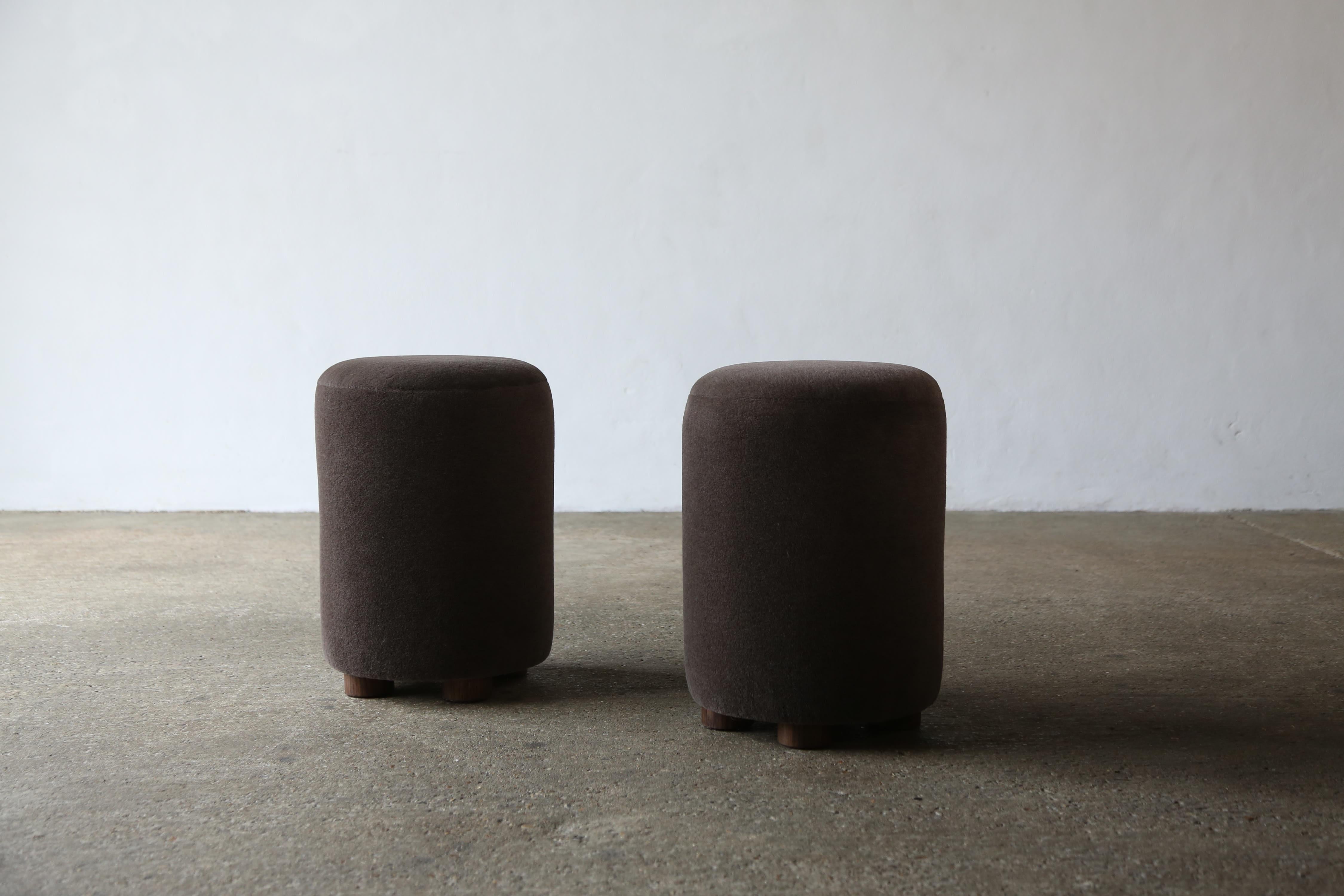 A superb pair of modern round ottomans.  Handmade in England.  Newly upholstered in a premium, soft, pure alpaca wool fabric with solid oak feet.    Custom sizes and fabric options available.    Fast shipping worldwide.


