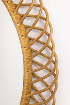 Pair of round rattan mirrors with interlacing. 1980s.