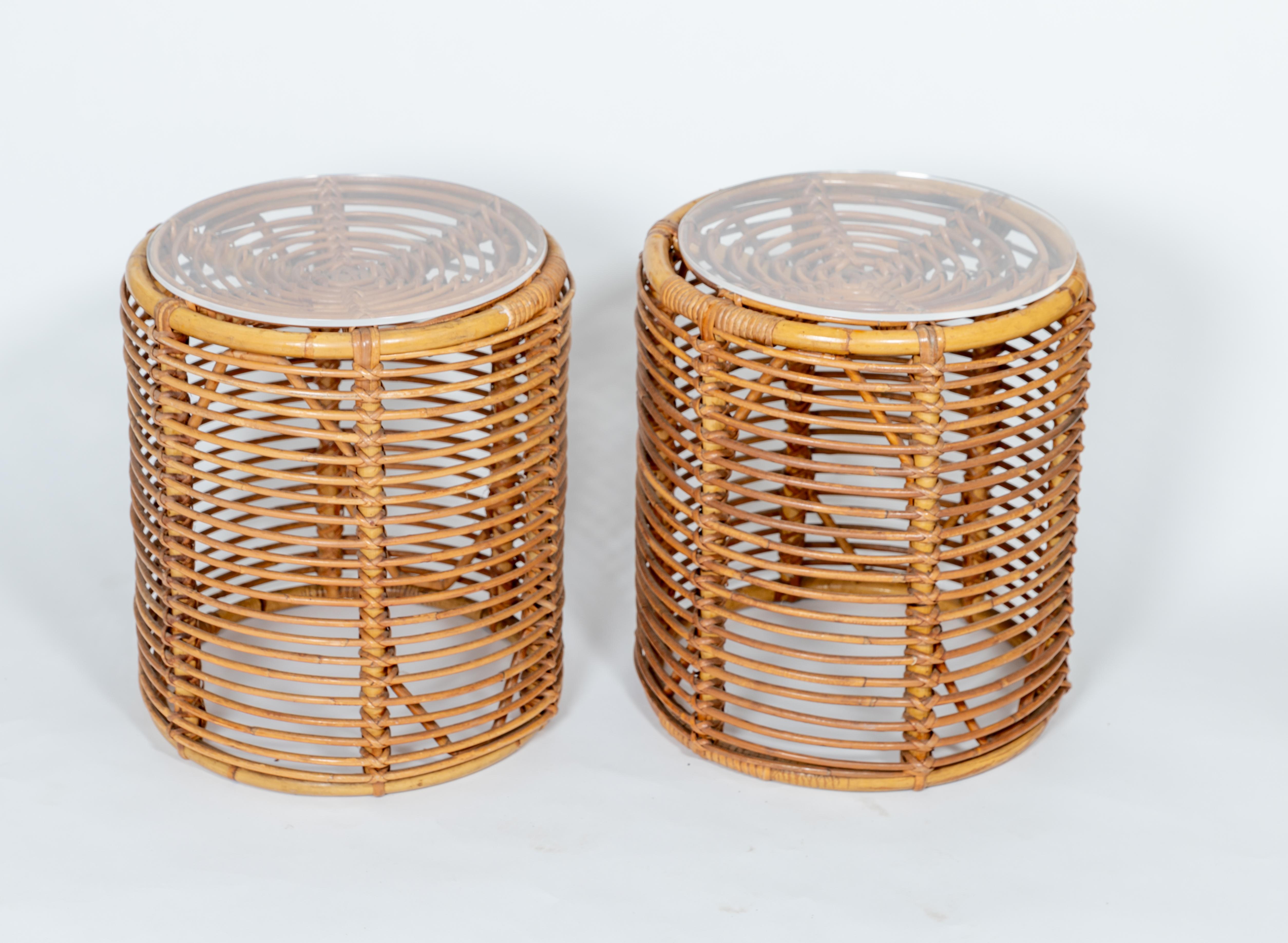 Pair of round rattan ottomans, with round Lucite tops.