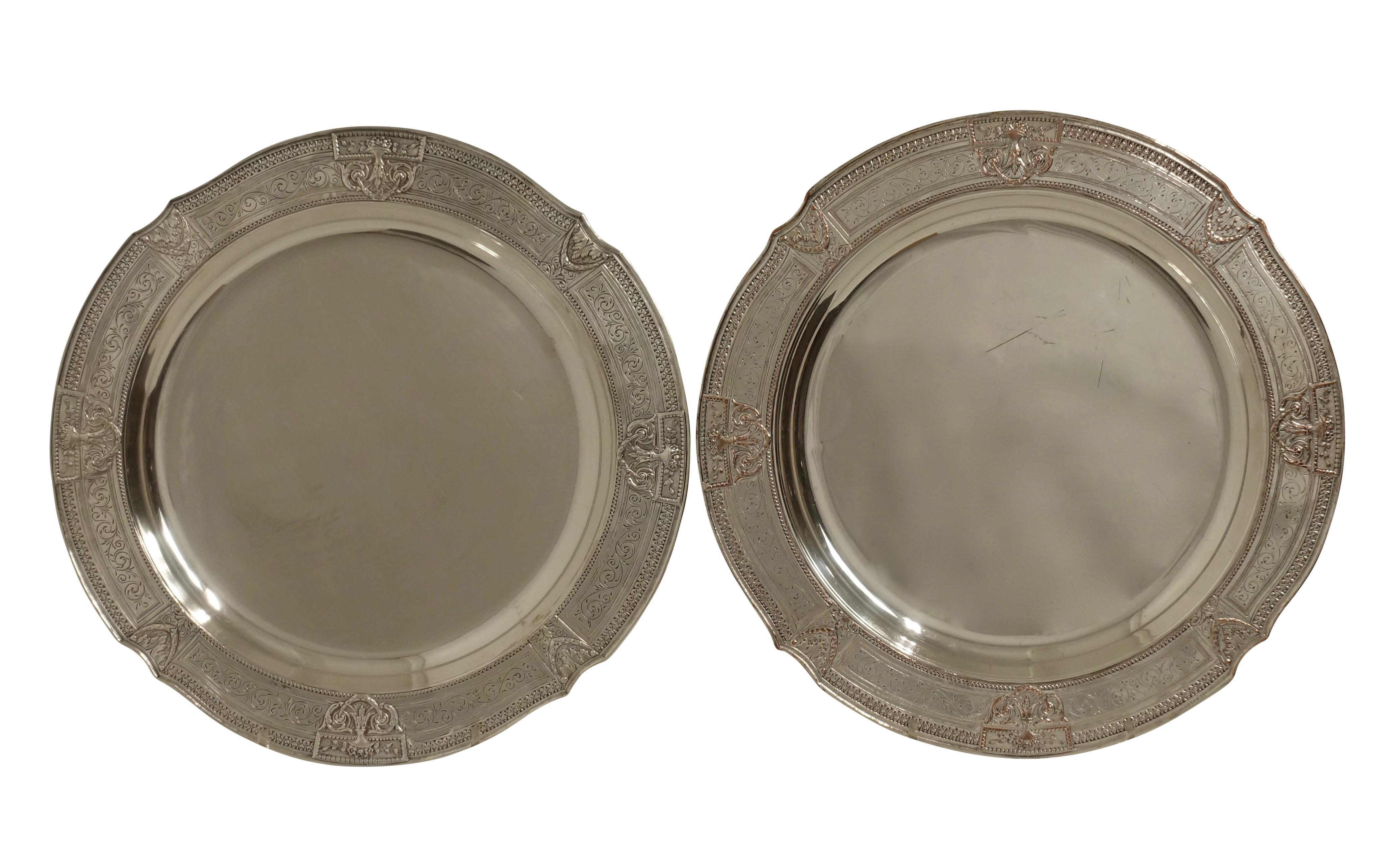 Pair of round neoclassical style silver plate on copper trays with flanking medallions of urns with swags and border of scrolling acanthus leaves. Both have impressed marks on the underside for E. G. Webster of New York, circa 1900.