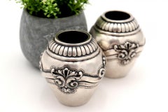 Pair of round silver pots with shells and reliefs