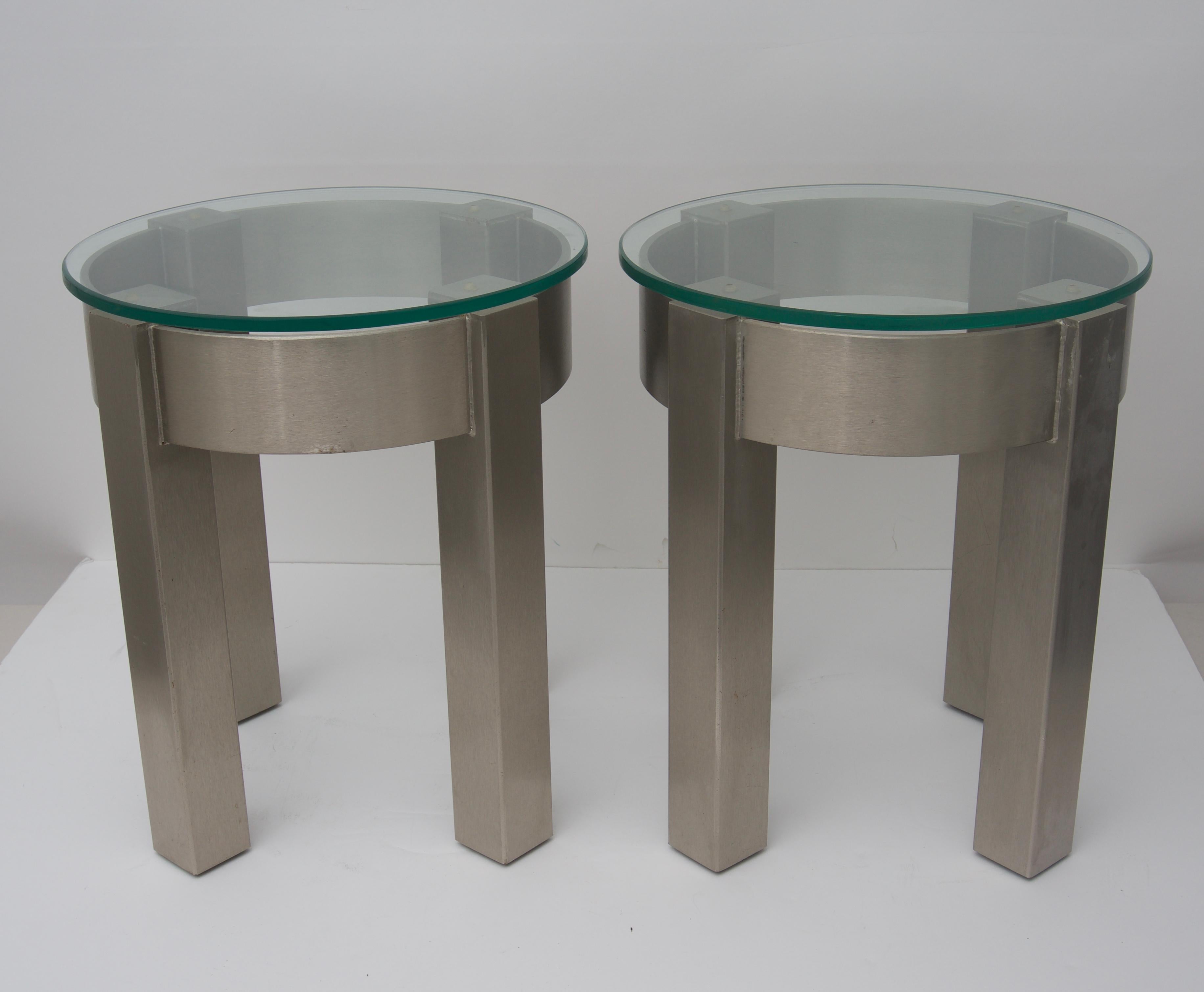This stylish set of side tables are fabricated in stainless steel with removable glass tops.