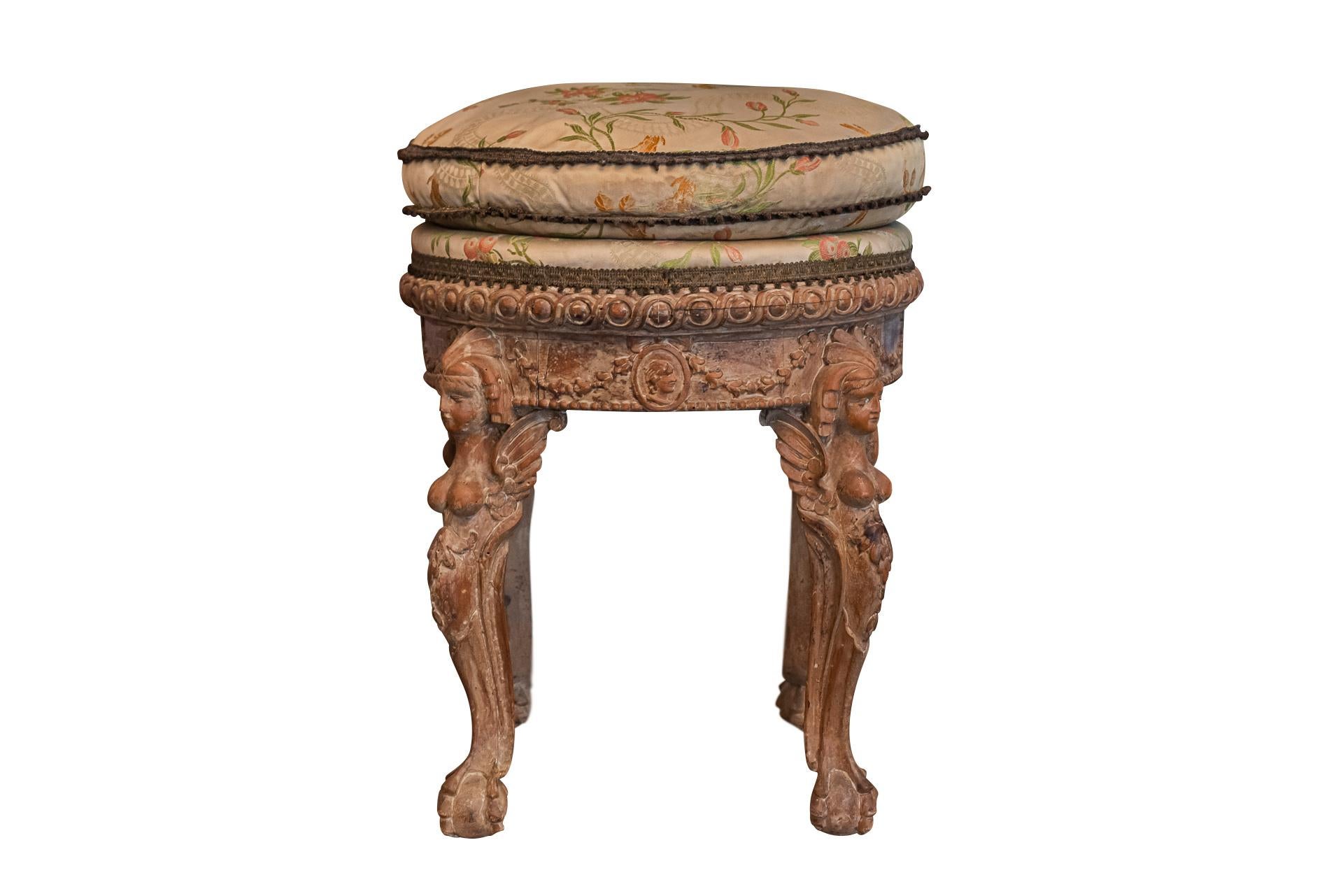Pair of round stools,
Carved wood decorated with winged sphinxes, pearl frieze and laurel friezes,
Feet claw and ball,
Trim attached with flower and bird decoration,
Late 18th century, France. 

Measures : Diameter 43 cm, height 51 cm.