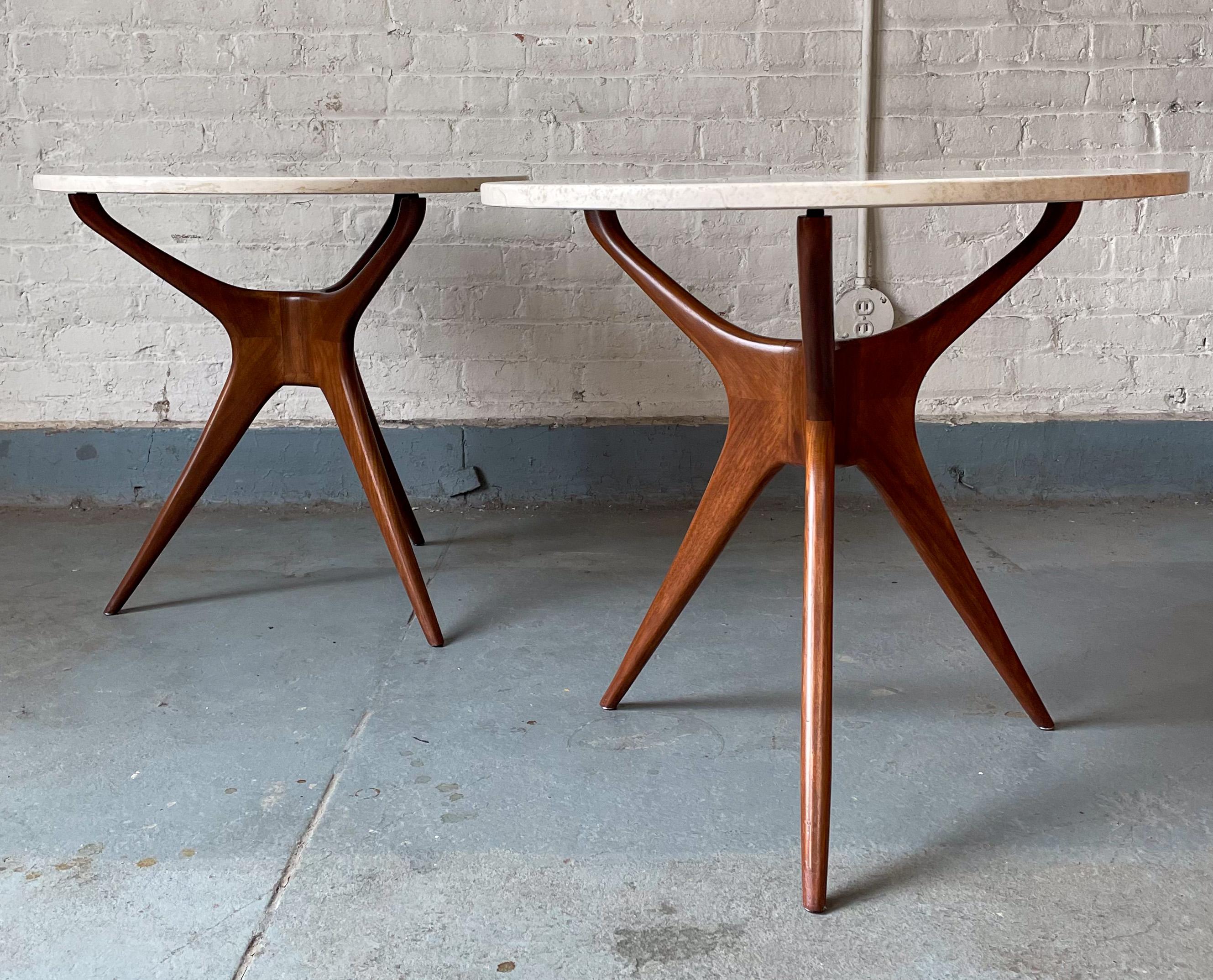 Pair of trisymmetric side tables in walnut with round Travertine marble tops. In the manner of Vladimir Kagan, produced late 20th century. A good quality production, with nicely figured wood and good polished marble, but not jointed the same as a