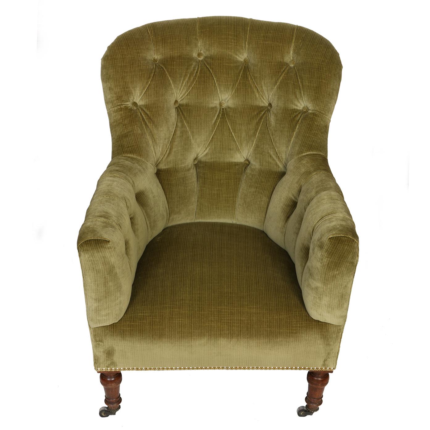 A pair of rounded back button tufted club chairs newly reupholstered in green strie velvet fabric. The lush green strie velvet upholstery envelops the chair, inviting you to indulge in a sensory experience of softness and opulence. The rounded back