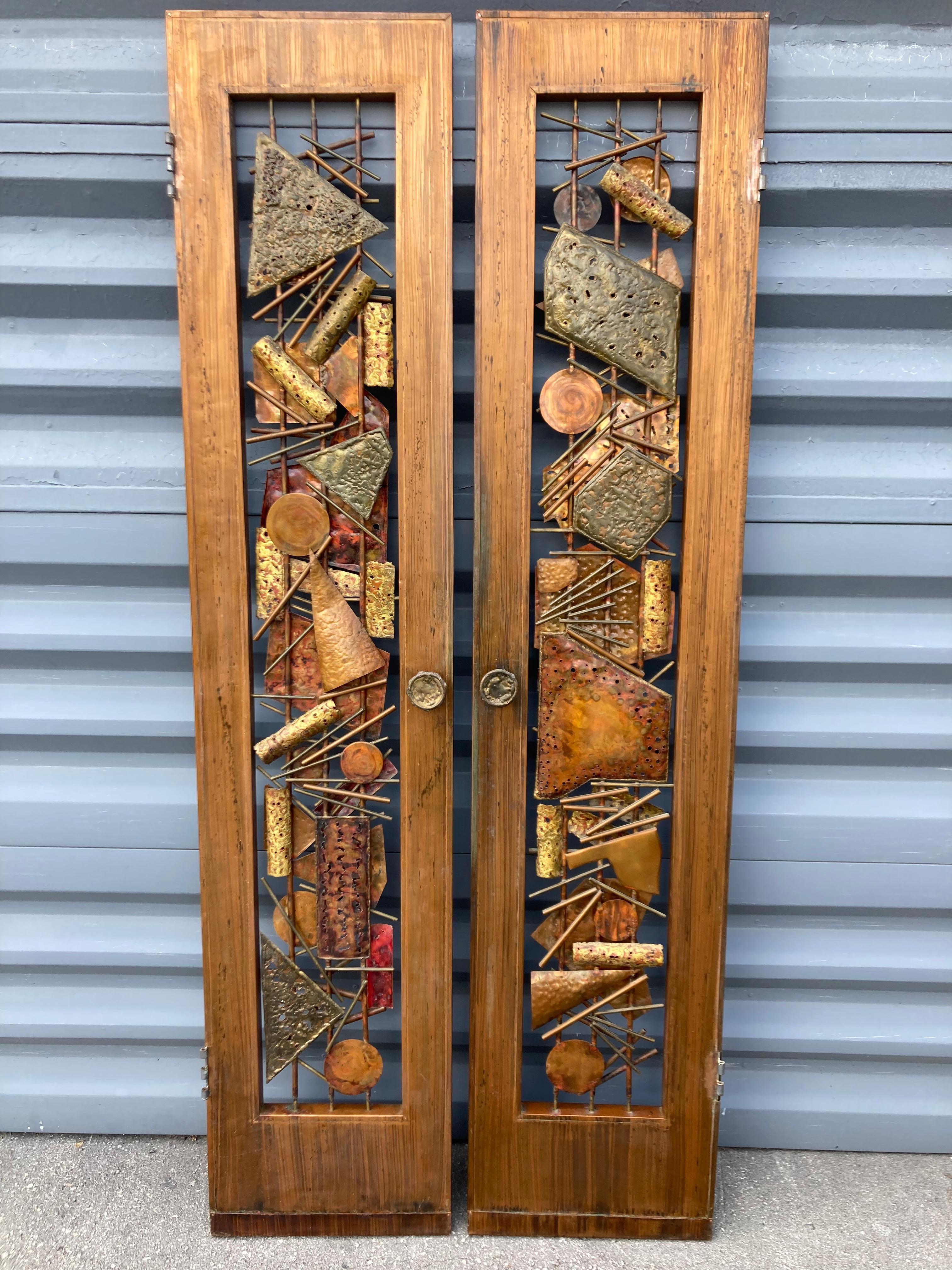Pair of Roy R. Butler Copper Doors, bought from the original owner. Signed, please see pictures.
Measures: One door is 17.13 wide and the other is 16.88 wide. 
The depth of 1.50” is measured without door knobs.