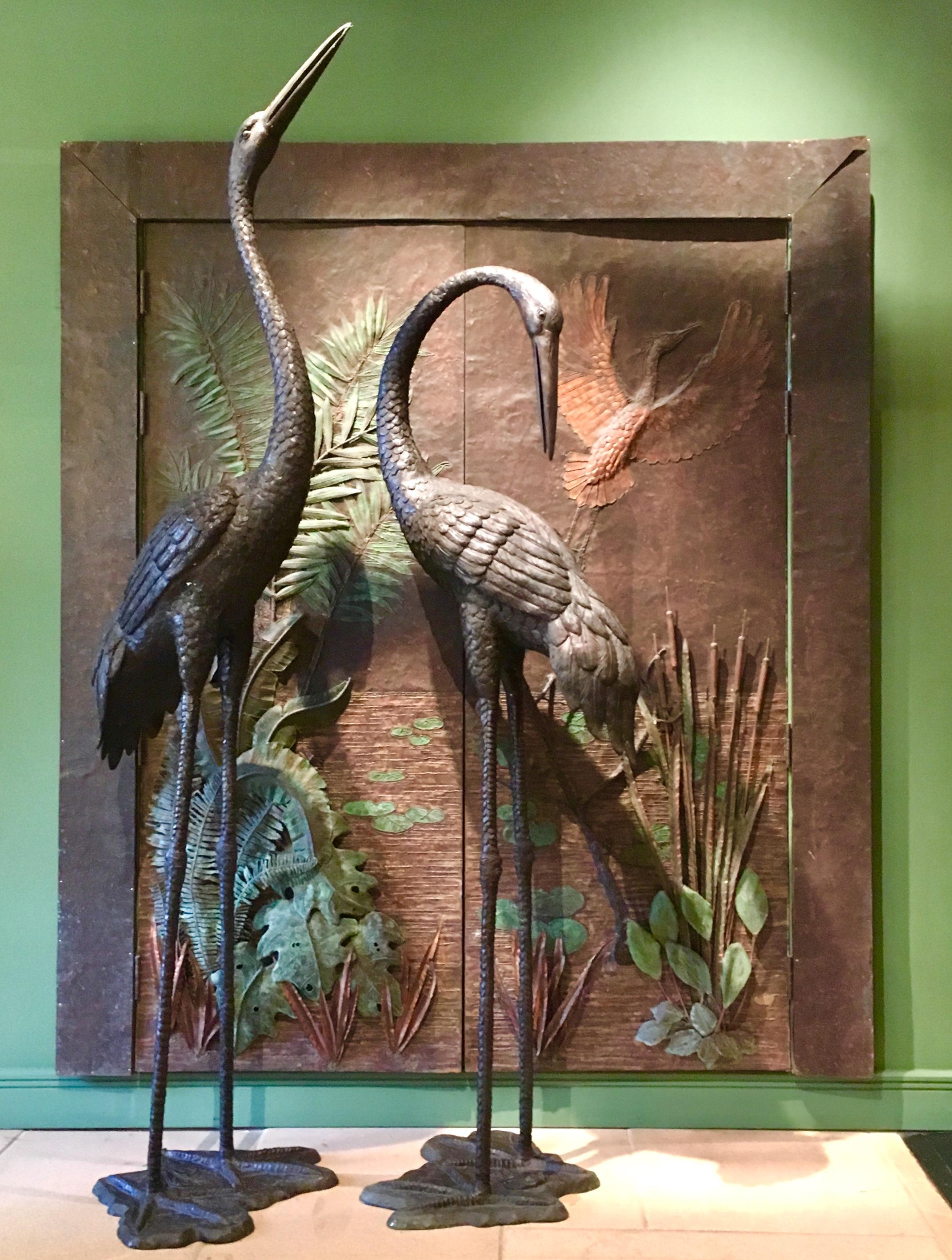 Impressive large pair of copper wrapped doors by Roy R Butler. 

Depicted is a waters edge scene of reeds, ferns and floating lily pads with a heron taking flight in the background. The opposing side of the doors have sculptural metal branch-like