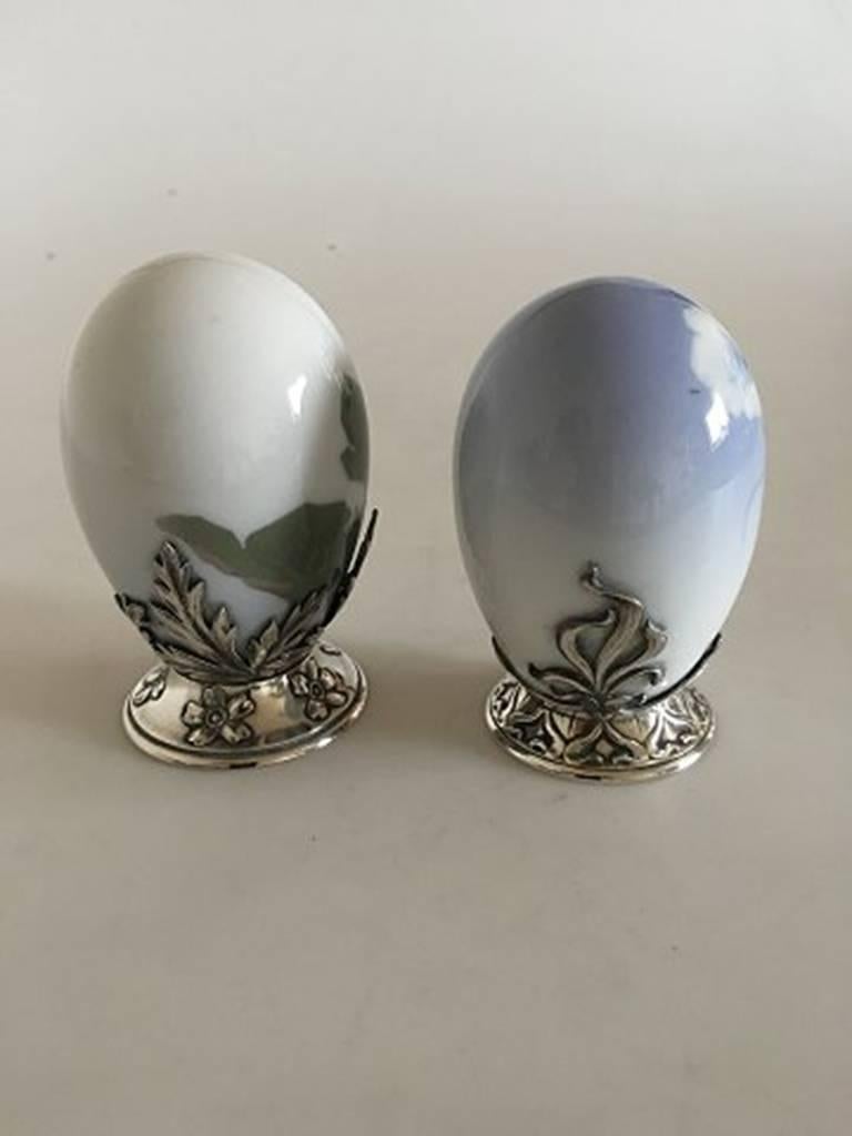 Pair of Royal Copenhagen Art Nouveau eggs with A. Michelsen sterling silver mounted pieces. The porcelain eggs are in perfect condition. Both are 9 cm tall (3 35/64 in).