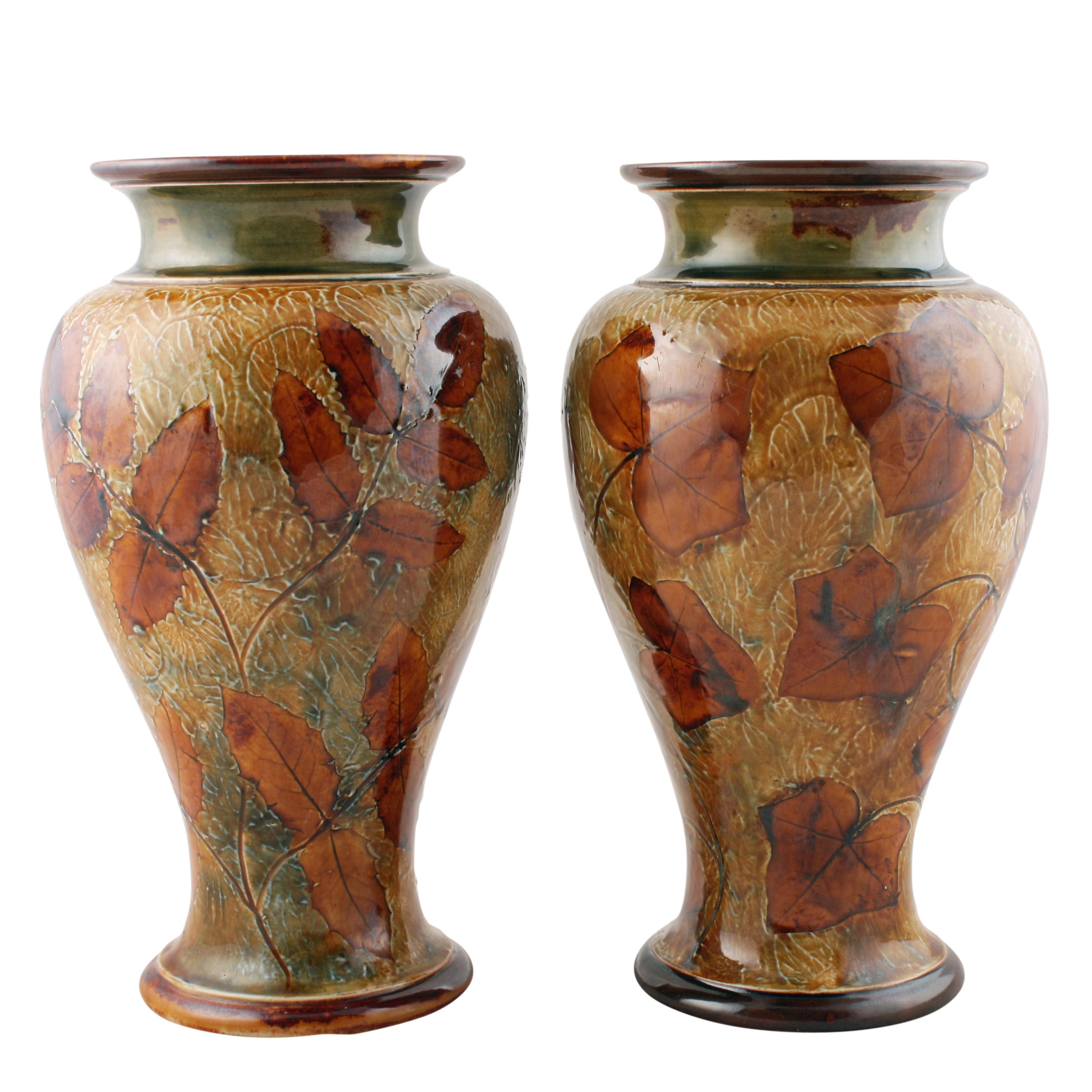 Pair of Royal Doulton vases


A pair of early 20th century Edwardian Royal Doulton glazed pottery vases.

The vases are decorated with natural looking leaves (possibly rose & lily leaves) on one and rose leaves on the other.

The undersides