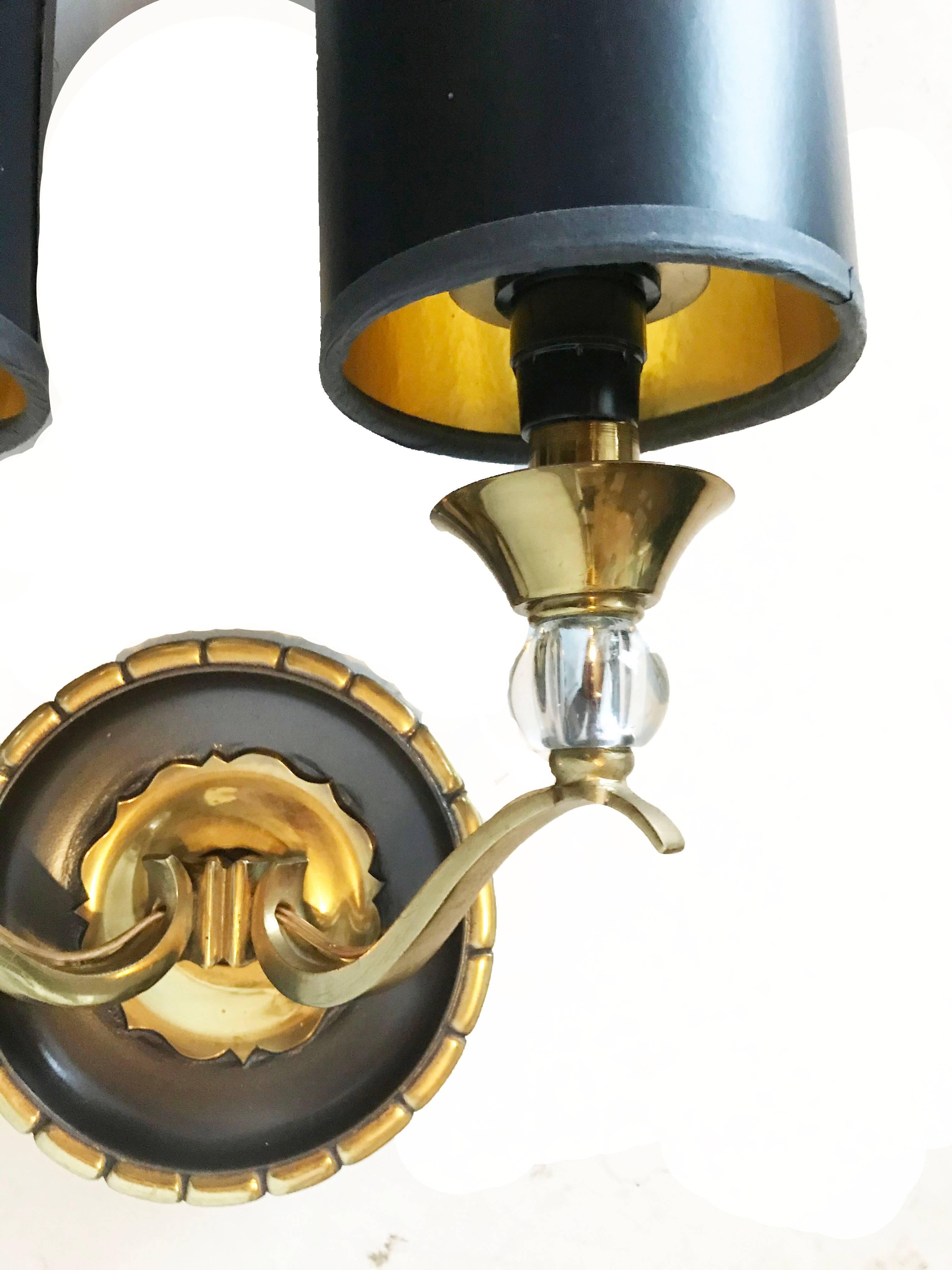 Superb pair of two-tone bronze sconces by Royal Lumière.
Two lights, 40 watts max bulb.
Measures: Back plates: 5.25 inches diameter.
New Black & Gold paper shades: 8 inches height, 4 inches diameter.