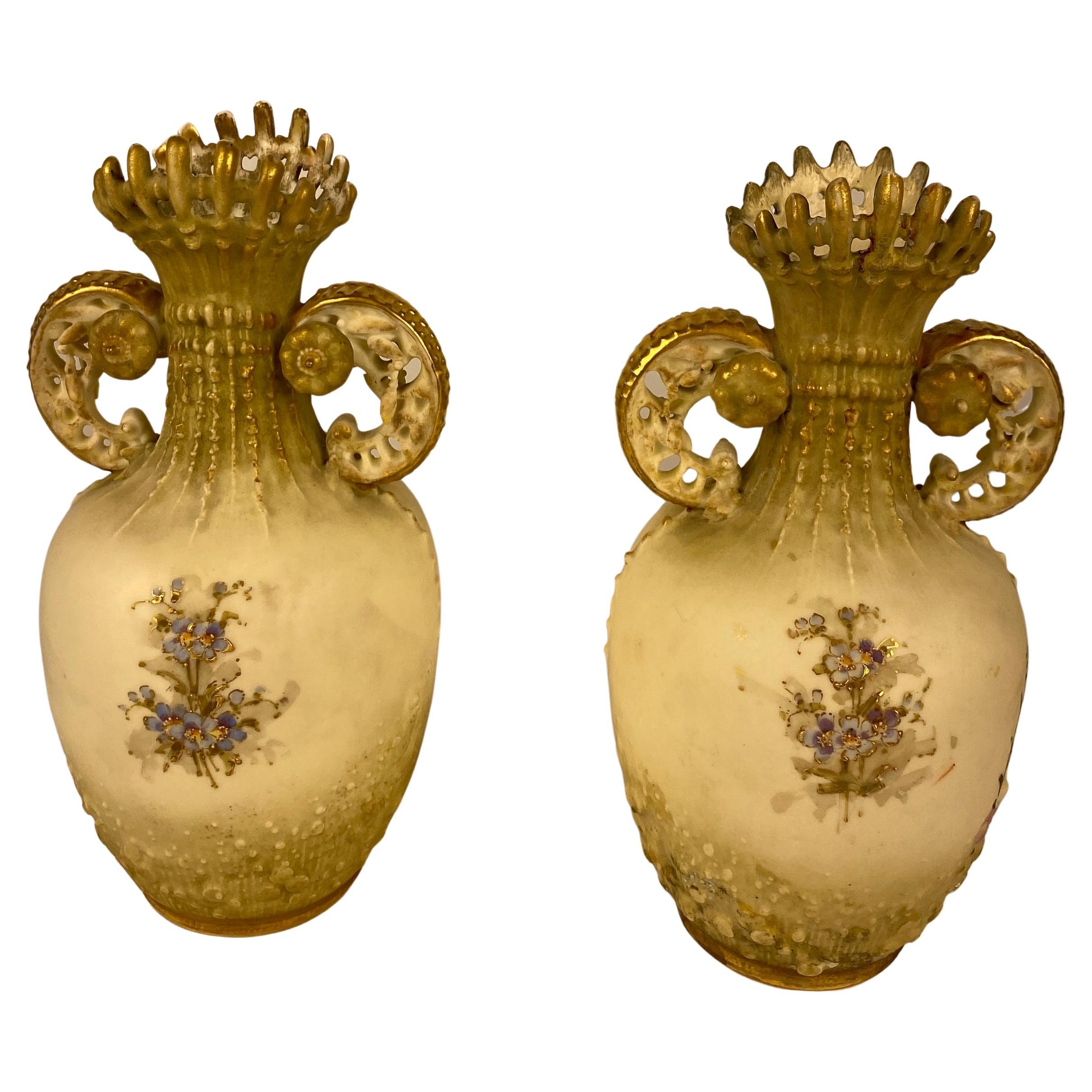 A superb pair of vases made in the manner of Royal Worcester pieces that were made around 1890. These vases are uniquely shaped and have a blush ivory Japanese lotus decoration.

This style was influenced by the wonderful Persian artefacts that
