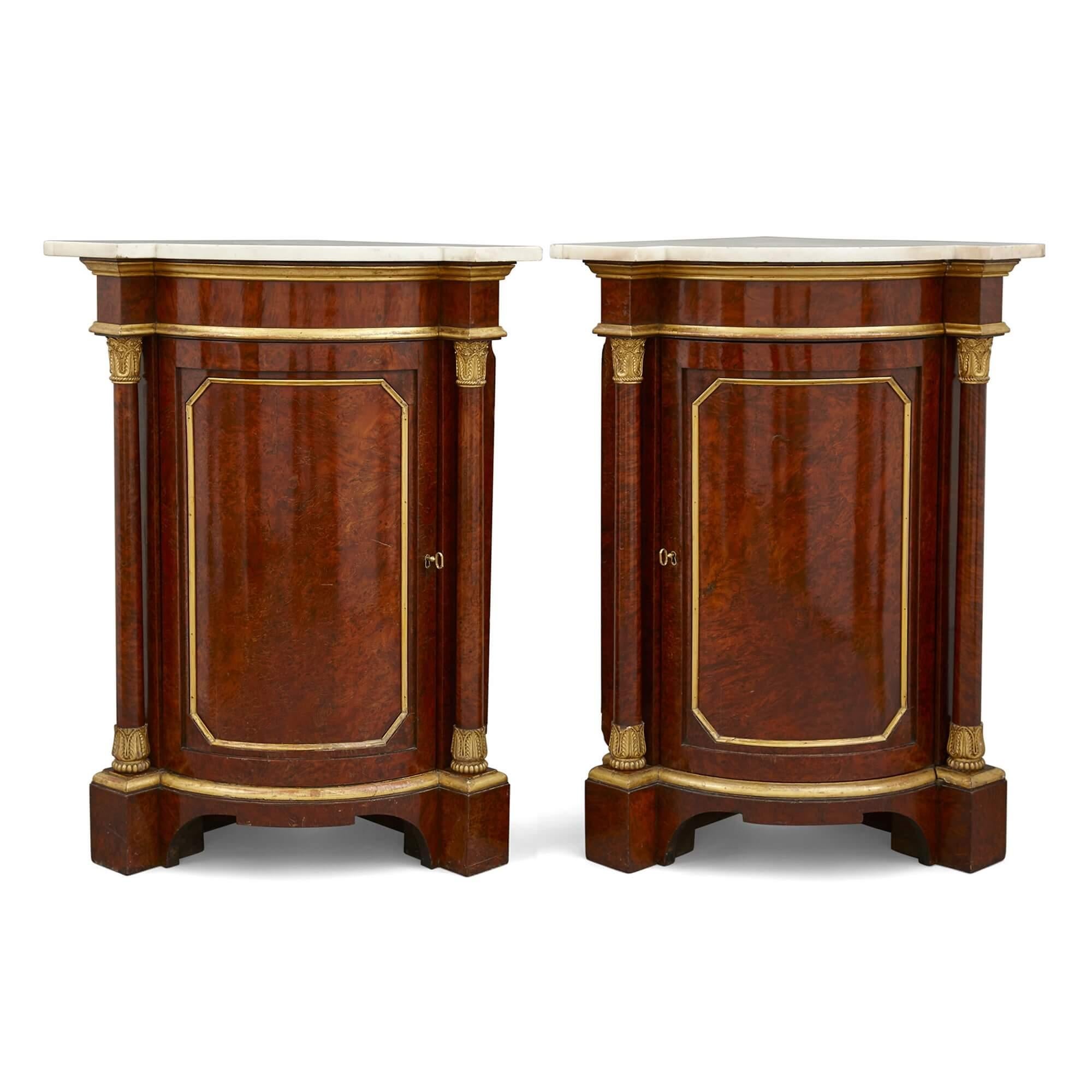 Pair of Victorian corner cabinets of Windsor Castle provenance
English, 19th Century
Measures: Height 96cm, width 74cm, depth 50cm

These superb corner cabinets are crafted from lustrous wood, gilt bronze, and marble. The cabinets feature shaped