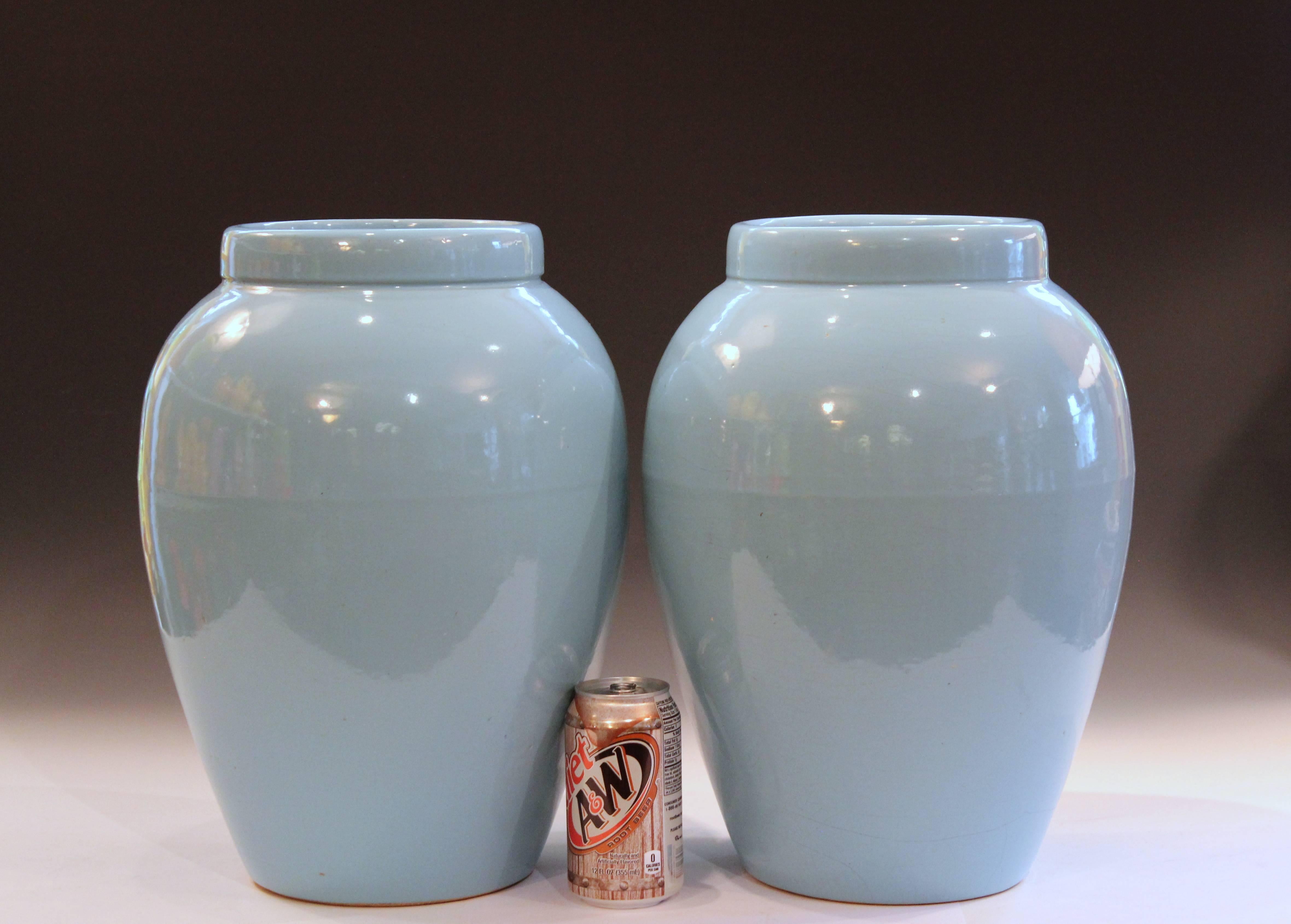 Large pair of Robinson Ransbottom oil jar urns in terrific sky blue monochrome glaze, circa 1930s. Measures: 15