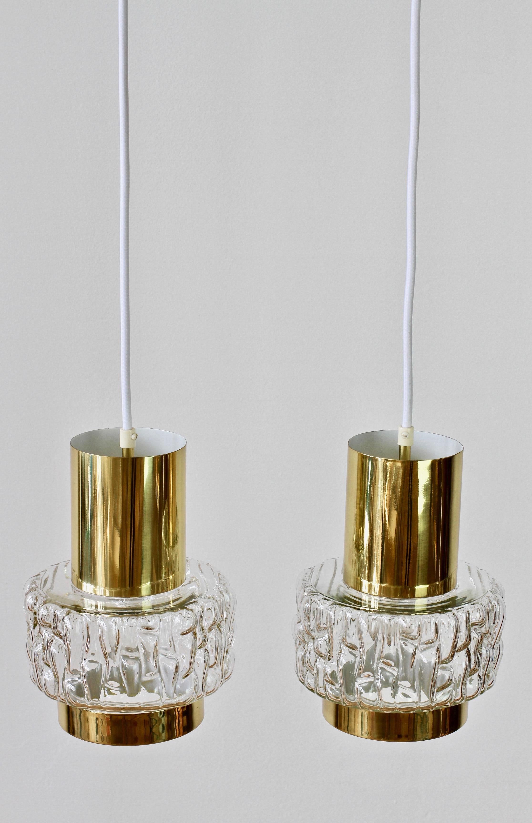 One of those special pieces which seldom becomes available. Stunning elegant pair of brass and clear textured bubble glass light fixtures by Austrian lighting firm Rupert Nikoll. Similar, in style, to fellow Austrian lighting manufacturer, J.T.