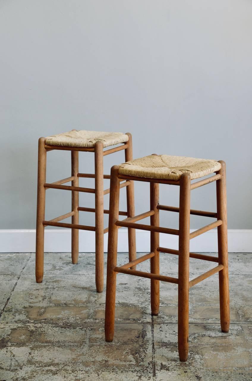 Pair of rush bar stools in the style of Charlotte Perriand.