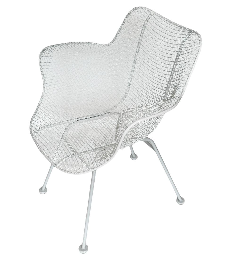 Newly powder coated in bright white is a beautiful matching set of sculpture wire lounge chairs designed by Russell Woodard in the 1950s. Suited for outdoor patio or inside use. The feature galvanized steel construction which is sculpted in an