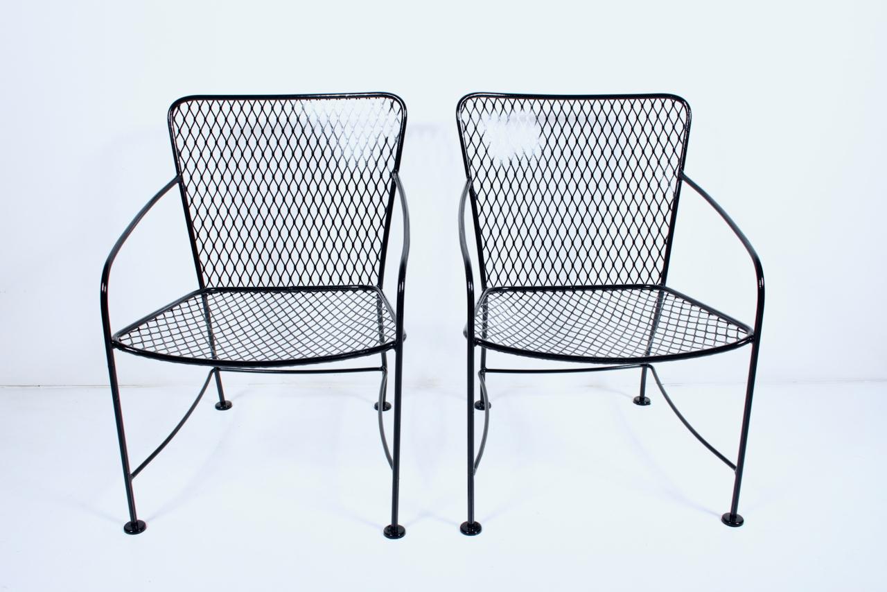 Pair of Russell Woodard attributed black enamel Wrought Iron Linai Chairs.
Featuring rugged, balanced frameworks, handcrafted in black enameled wrought iron, with comfortable woven wire mesh seats and ergonomic curved backs, finished with cupped