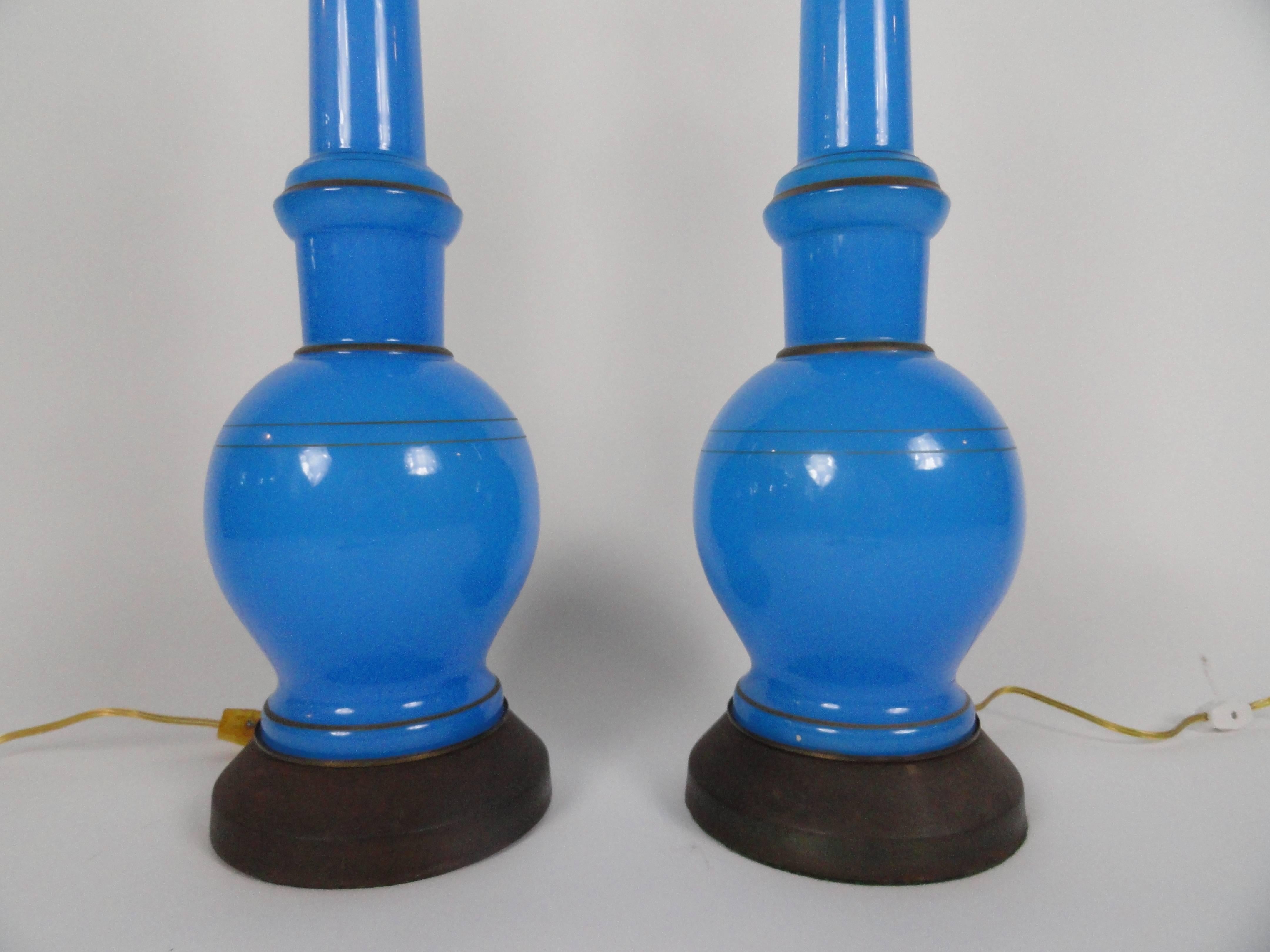 Pair of Russian blue opaline glass lamps with applied gilt decoration and brass bases. These are truly beautiful lamps with a spectacular blue color. Rewired with inline switches.