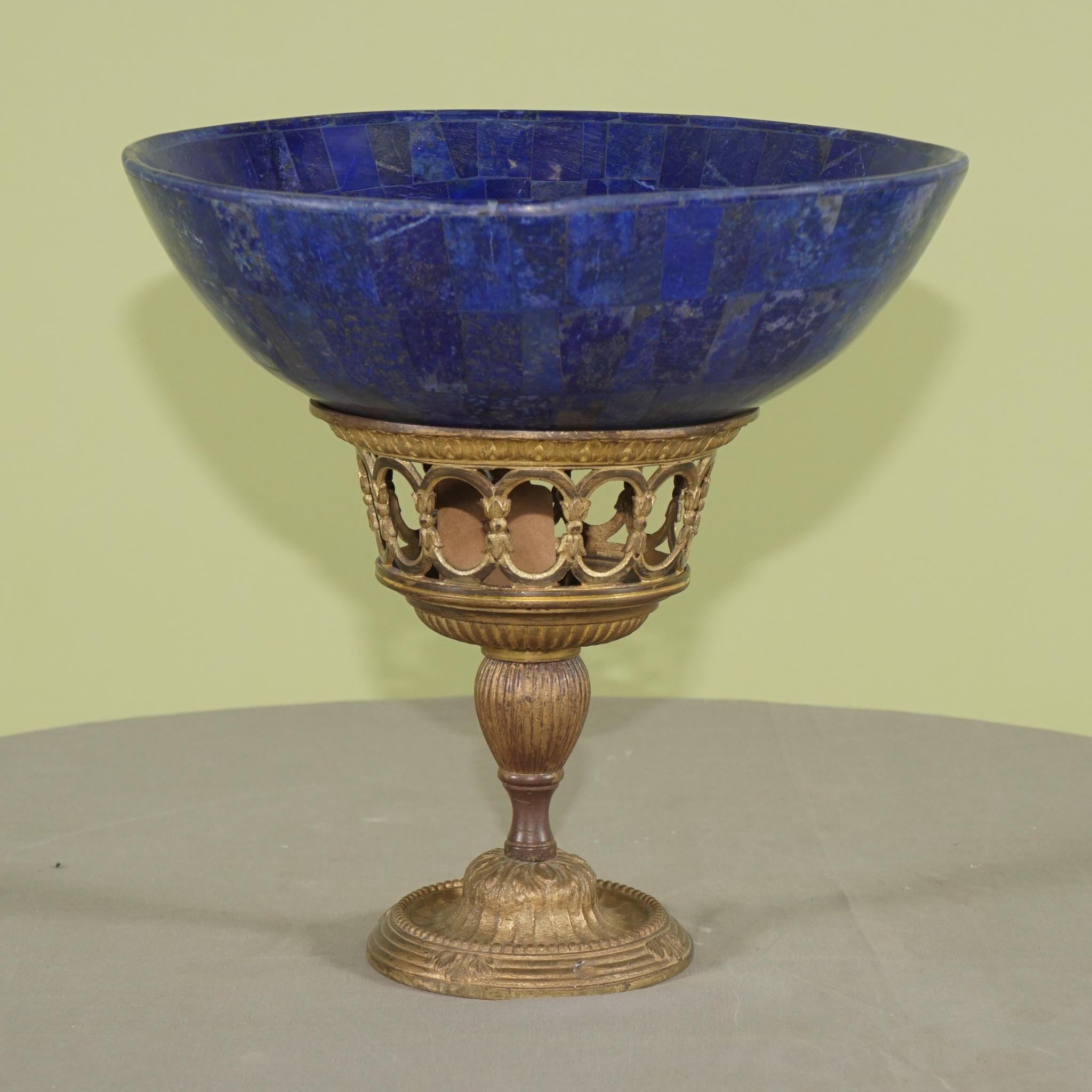 This pair of bowls made of lapis lazuli in the 20th century are set up on older gilded bronze stands. They are made not from the solid but veneered in the manner of Russian furniture, urns or columns and other table top accessories made in the 18th