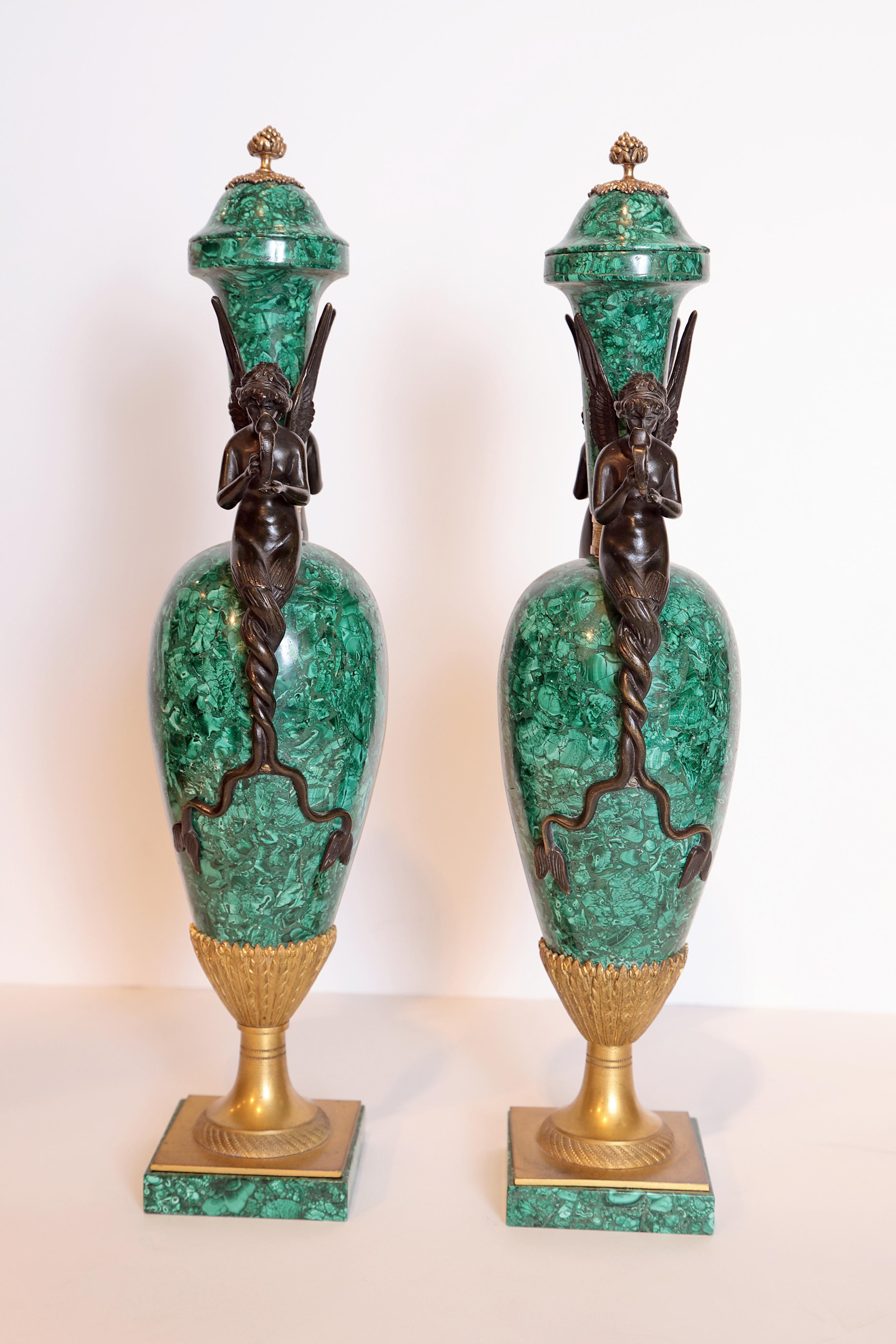 Pair of fine early 20th century malachite urns with patinated bronze water maidens on the side.