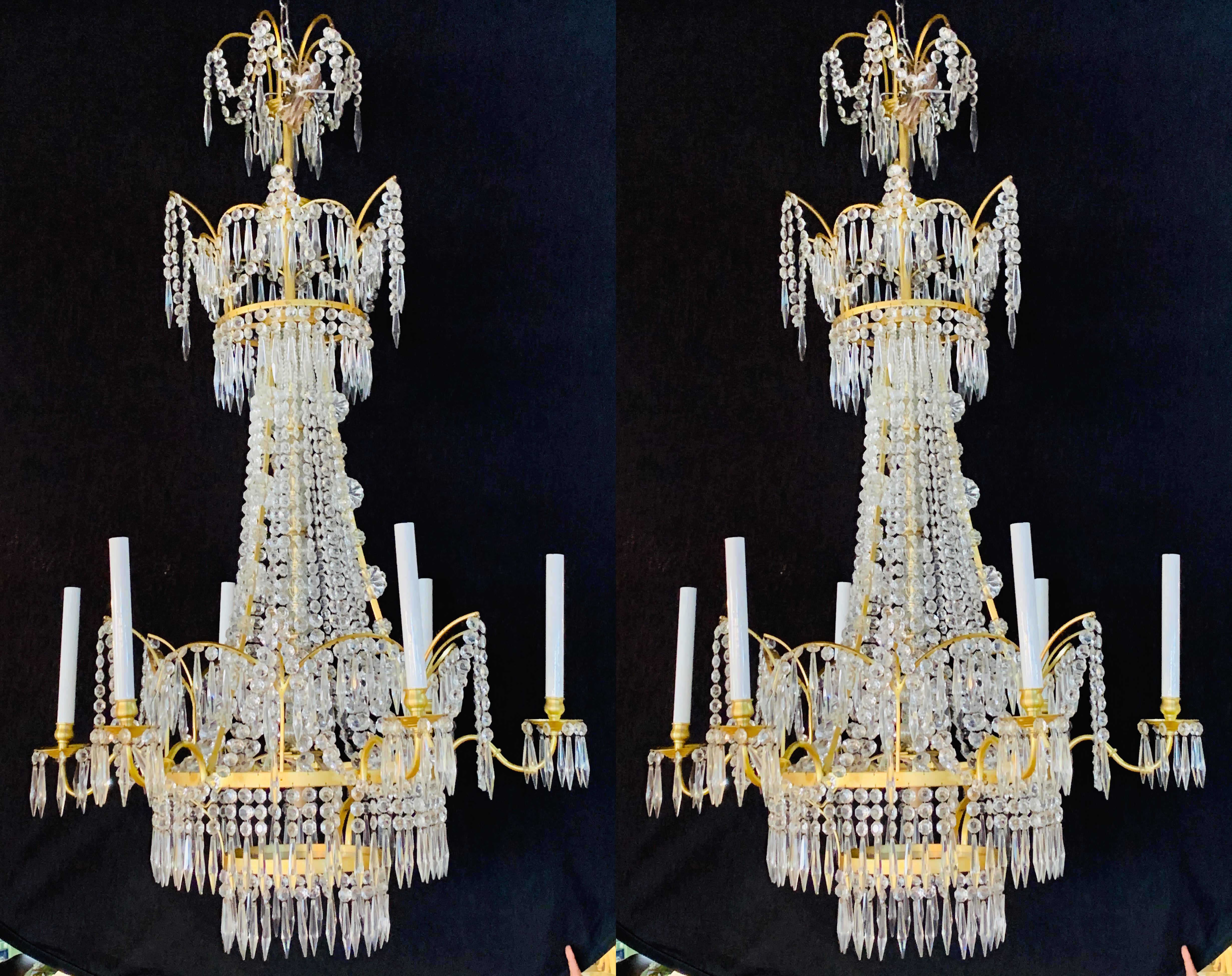 A spectacular pair of Russian neoclassical style bronze and crystal 7-light chandeliers. Each of these seven light newly wired fixtures are stunning and certain to sparkle as they are sure to light up any area in the home or office. The center