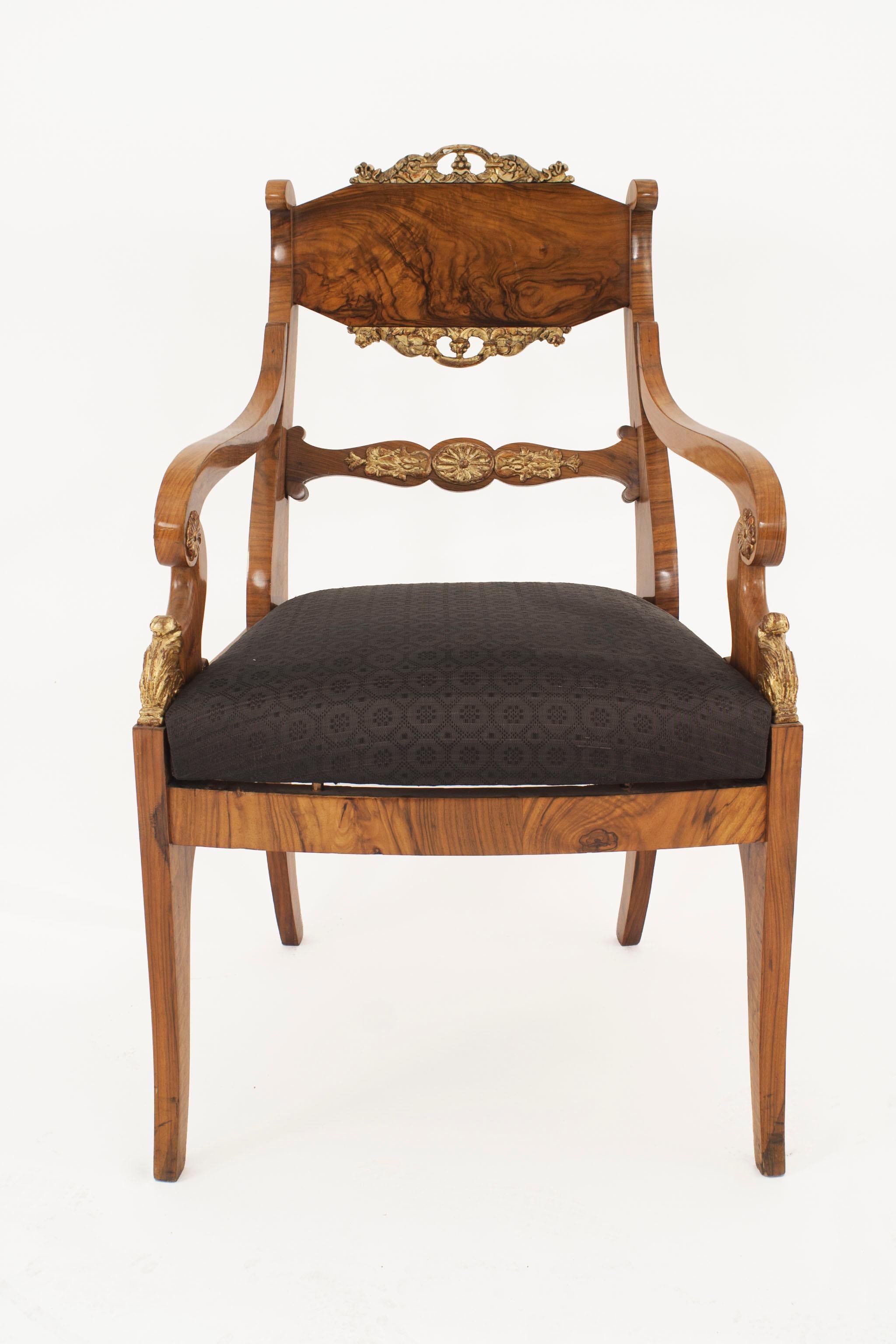 Pair of Russian Neo-classic walnut armchairs with parcel gilt trim and scroll design arms and carving with a slip seat (circa 1830)
