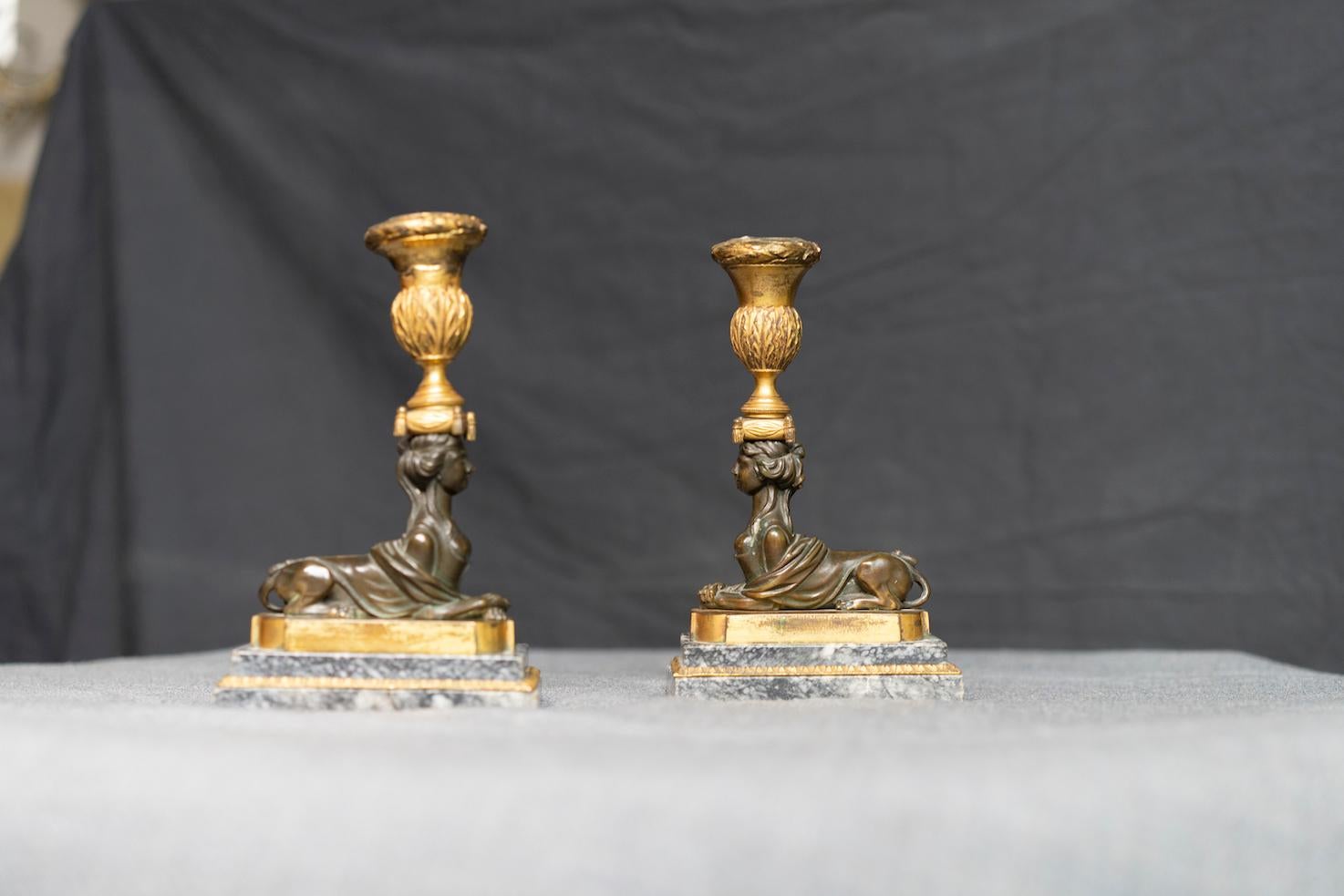 Pair of Russian Neoclassical Gilt and Patinated Bronze Sphinx Candlesticks In Good Condition For Sale In Montreal, QC