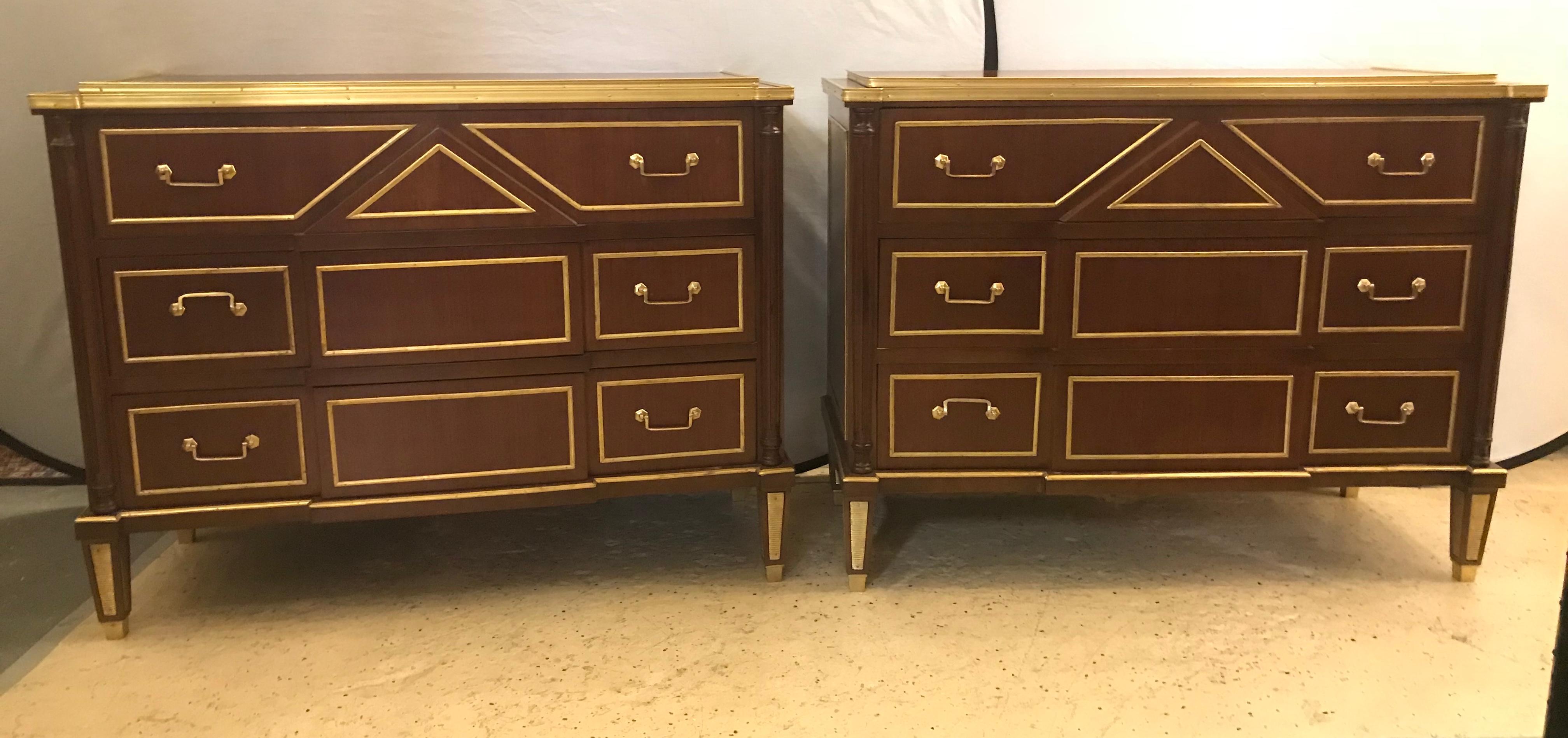 A pair of Russian neoclassical style commodes / bedside nightstands or servers. Stunning and showy are these fine three drawer wonderfully bronze mounted step up commodes or end tables. The bronze sabots tapering legs having reeded cookie cutter