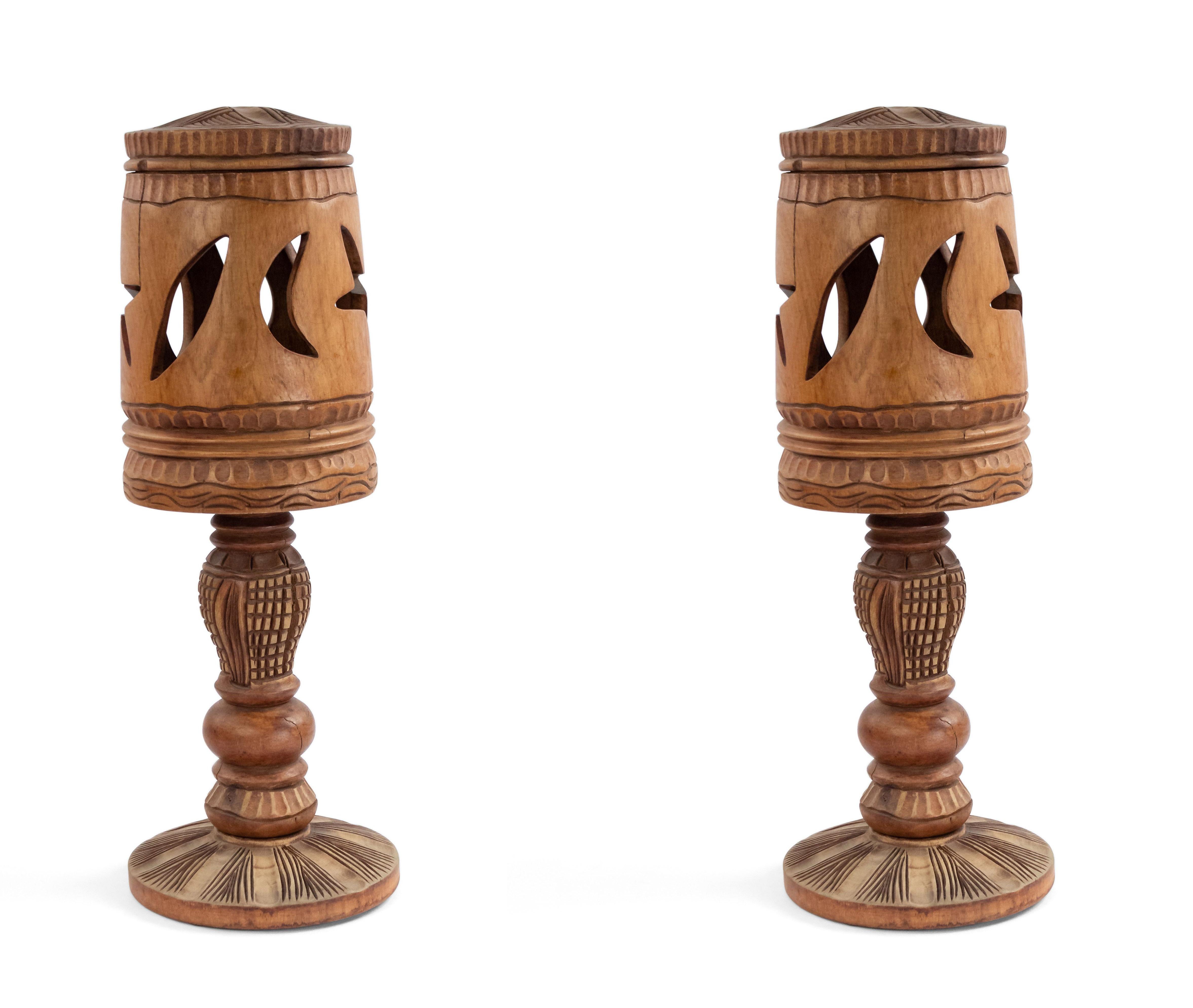 Pair of Rustic American Adirondack style (1930s possibly Haitian) light wood (three section) table lamps with carved moon and star cut-out design shade under a top cover.
 