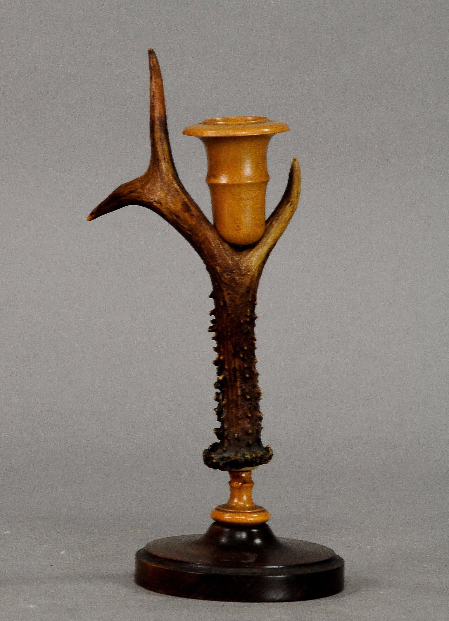 A pair of rustic candleholders, made of deer antlers, base and spouts made of turned wood. Executed in Germany, circa 1900.

Measures: Height 10.63