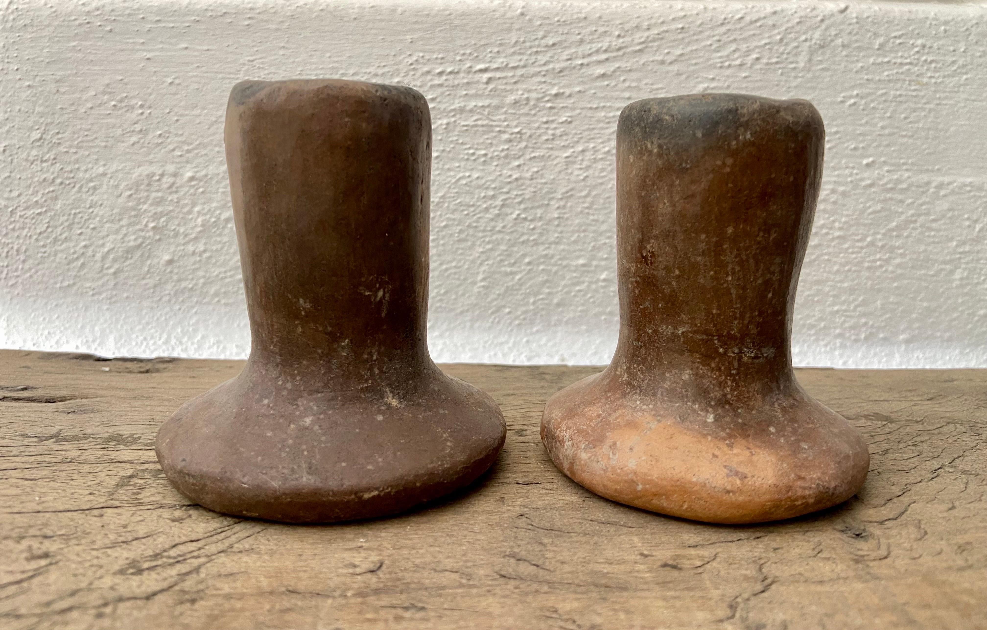 Pair of rustic ceramic candleholders from San Agustín Oapan, Guerrero, Mexico. This style of candleholders were prominent up until the 1980's when electricity was established in the town.