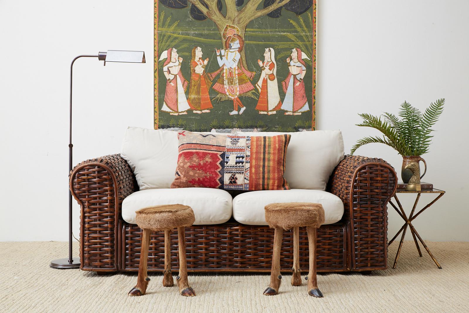 Chic pair of rustic French foot stools covered with deer fur and supported by three taxidermy legs ending with hoof feet. The top has a round wood form wrapped in fur matching the legs. These delicate stools are made for decorative purposes and