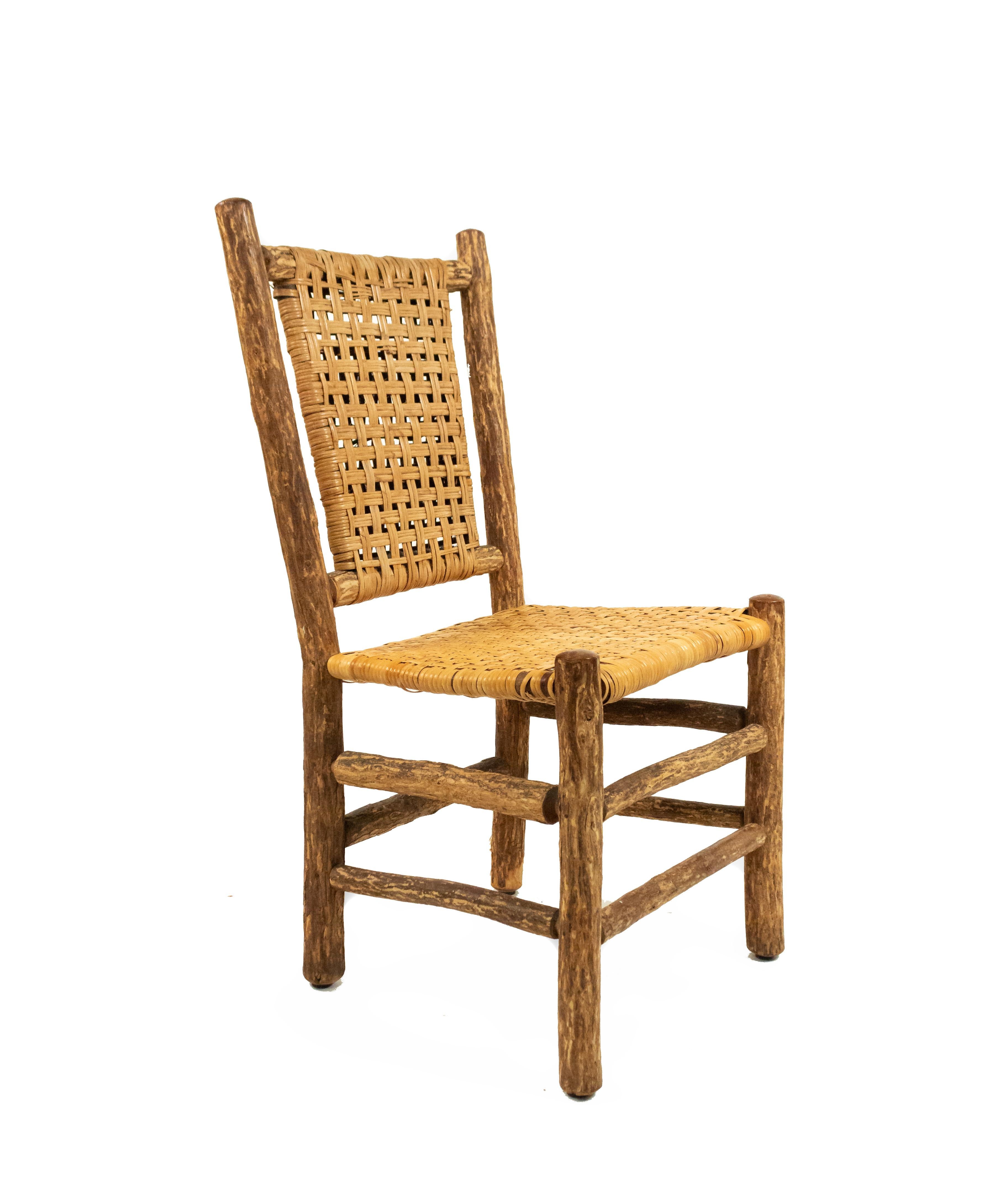 Pair of Rustic Old Hickory style (late 20th cent) side chairs with woven cane seats and backs.
     
