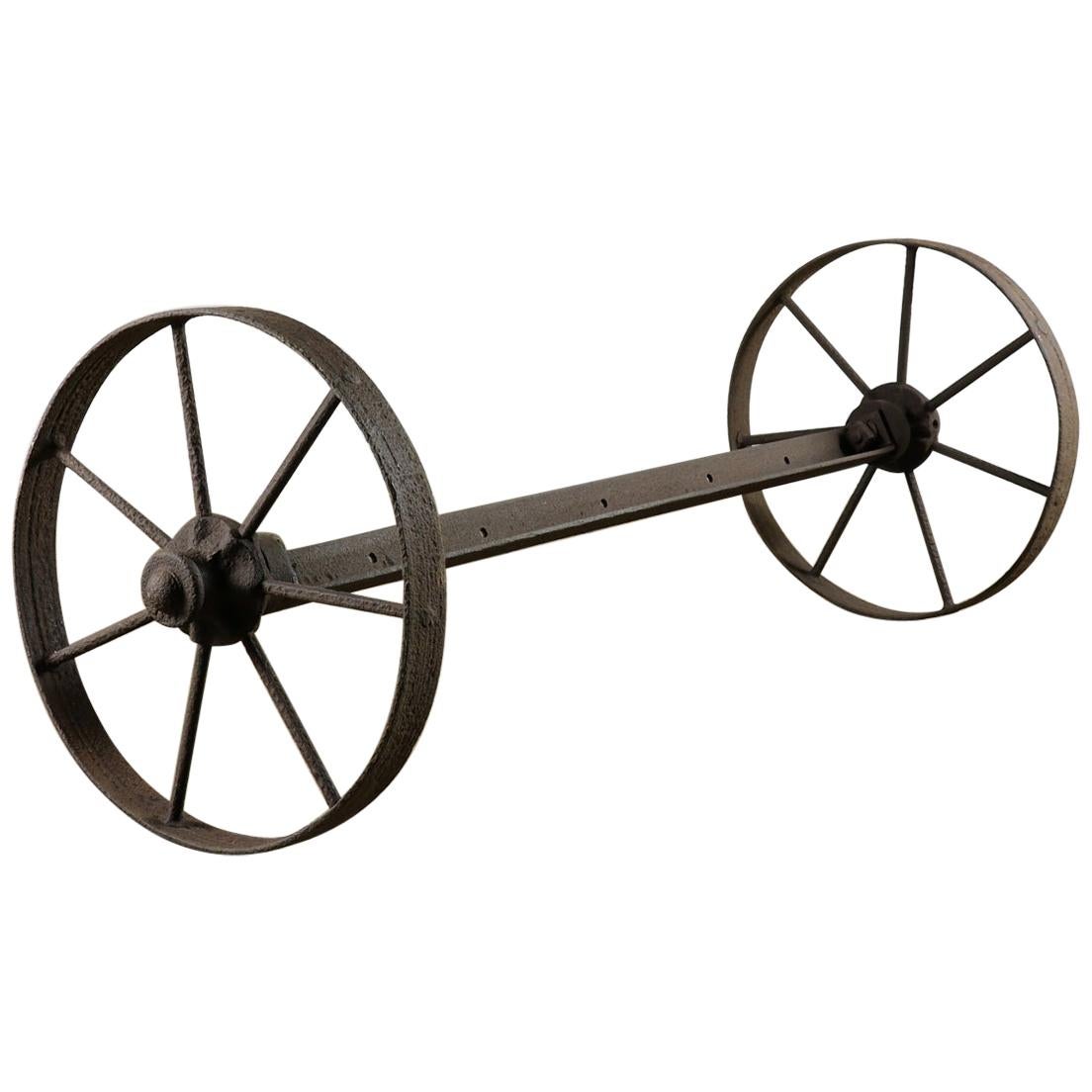 Pair of Rustic Old Cast Iron Wheels on Axle, 20th Century For Sale