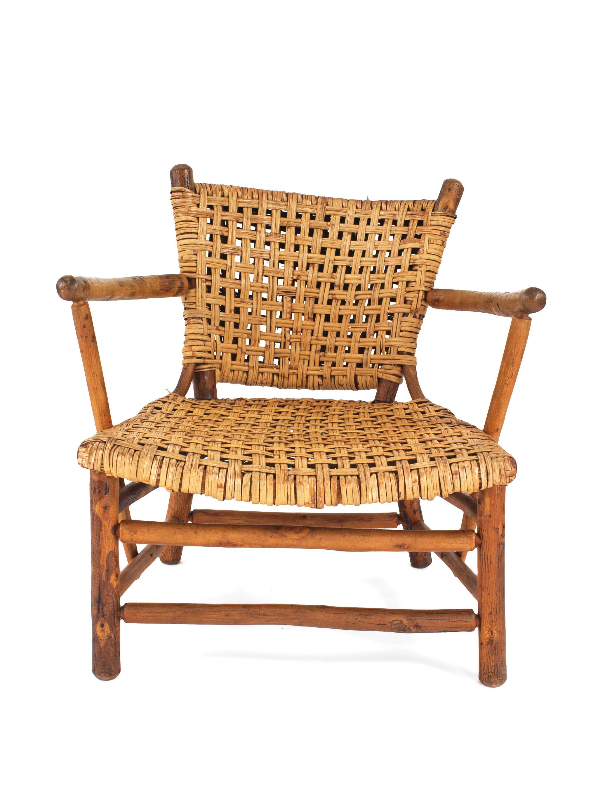 Pair of rustic old hickory low arm chairs with woven seats and backs.  See matching settee; dealer reference number 061005A.

Since 1899 Old Hickory Furniture has been handcrafted in Central Indiana using the remarkable hickory sapling and other
