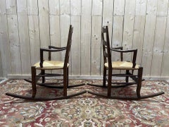 Pair of rustic solid oak rocking chairs with rush seats