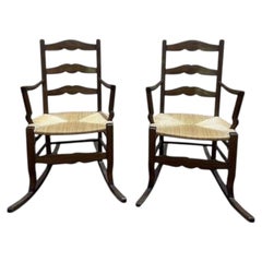 Pair of rustic solid oak rocking chairs with rush seats