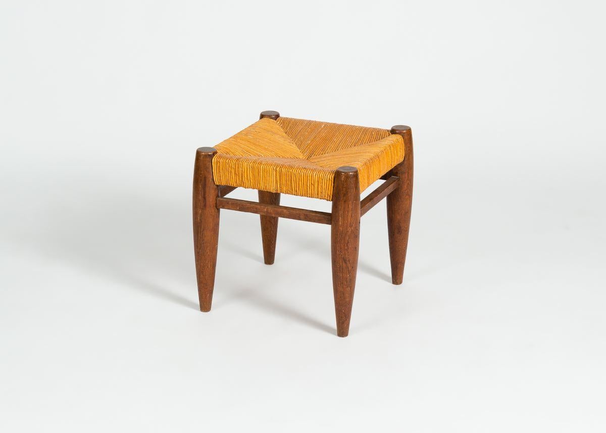 Beautiful stained wood and rattan stools in the manner of Charlotte Perriand.