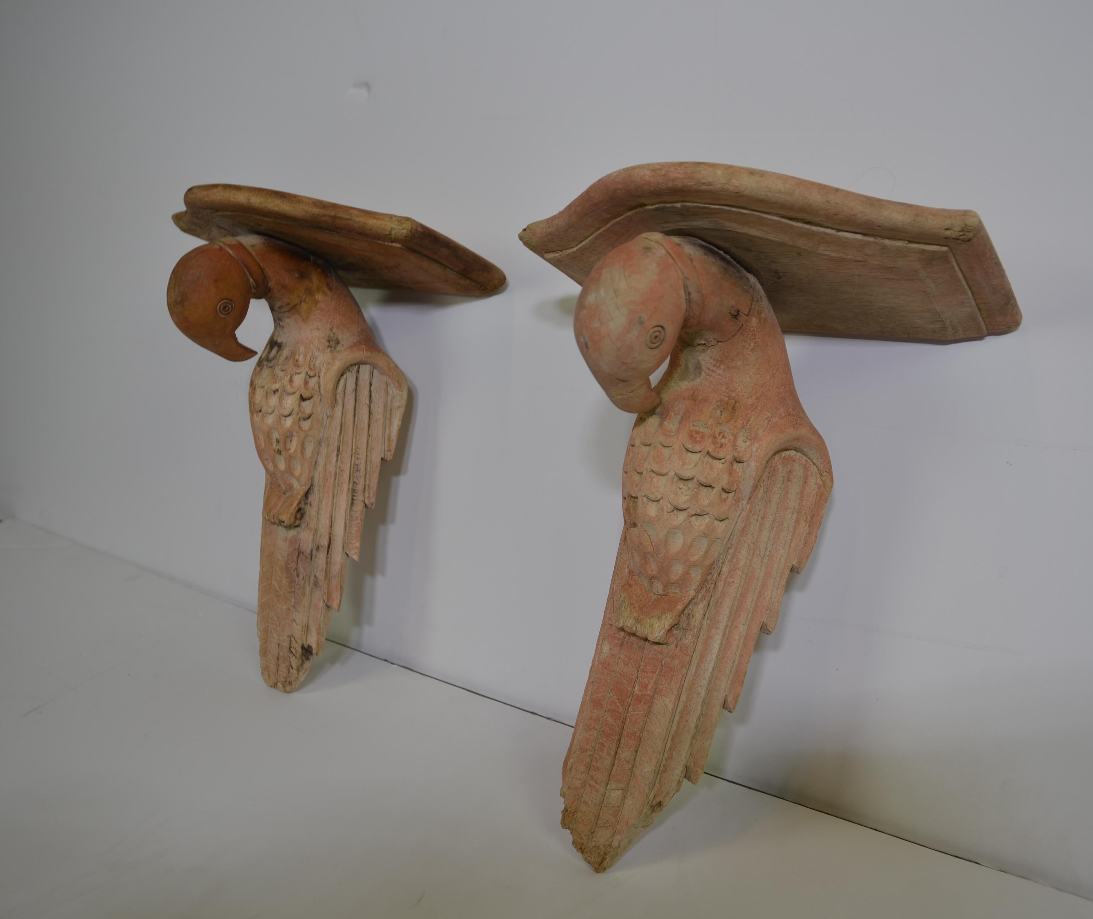 Pair of rustic wood-carved bird wall brackets.