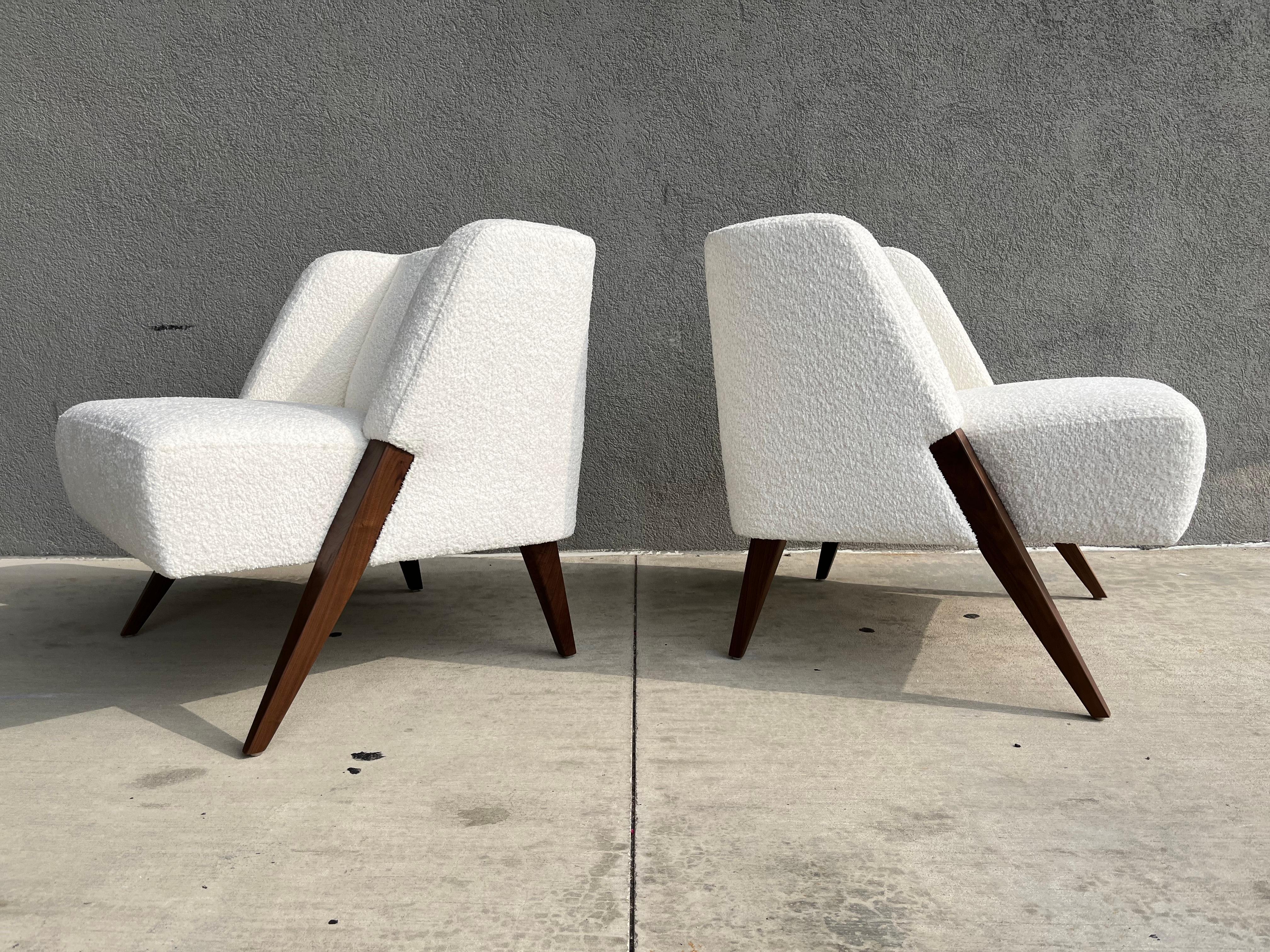 Incredible pair of RUTH lounge chairs by Dosbananos in the style of Gio Ponti. Solid walnut legs and ivory bouclé fabric. Ready for a new home.
