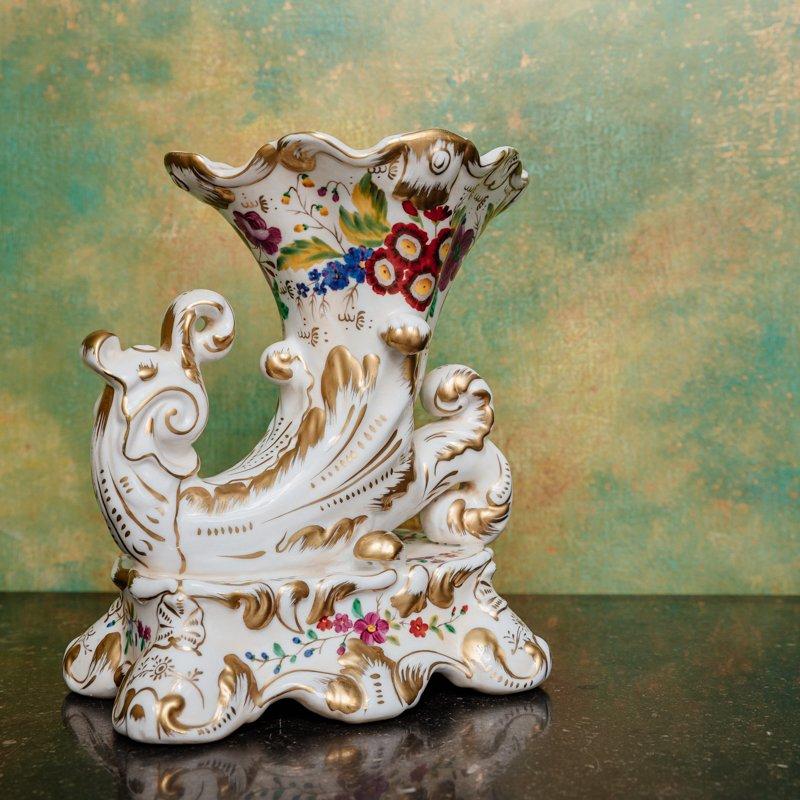 Very beautiful pair of polychrome porcelain “rhyton” vases, decorated with flowers on a white and gold background. It dates from the second half of the 19th century.
Dimensions of: H: 24 x L: 19 x W: 12.5cm

Originally, the rhyton was an antique