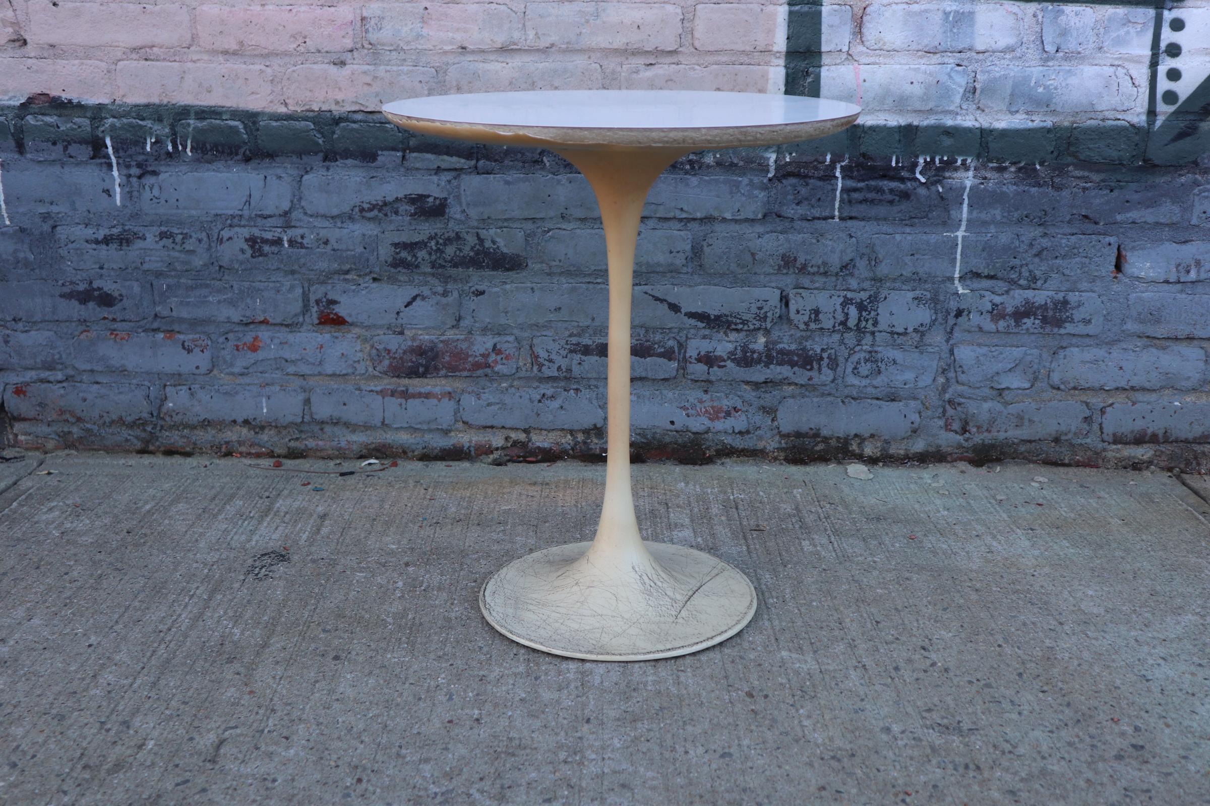 Pair of Saarinen style tulip tables by Burke. Wear along edges and gorgeous worn pint Patina to bases. Can be repainted for $199. Original pair in original condition. Laminate tops in great shape.