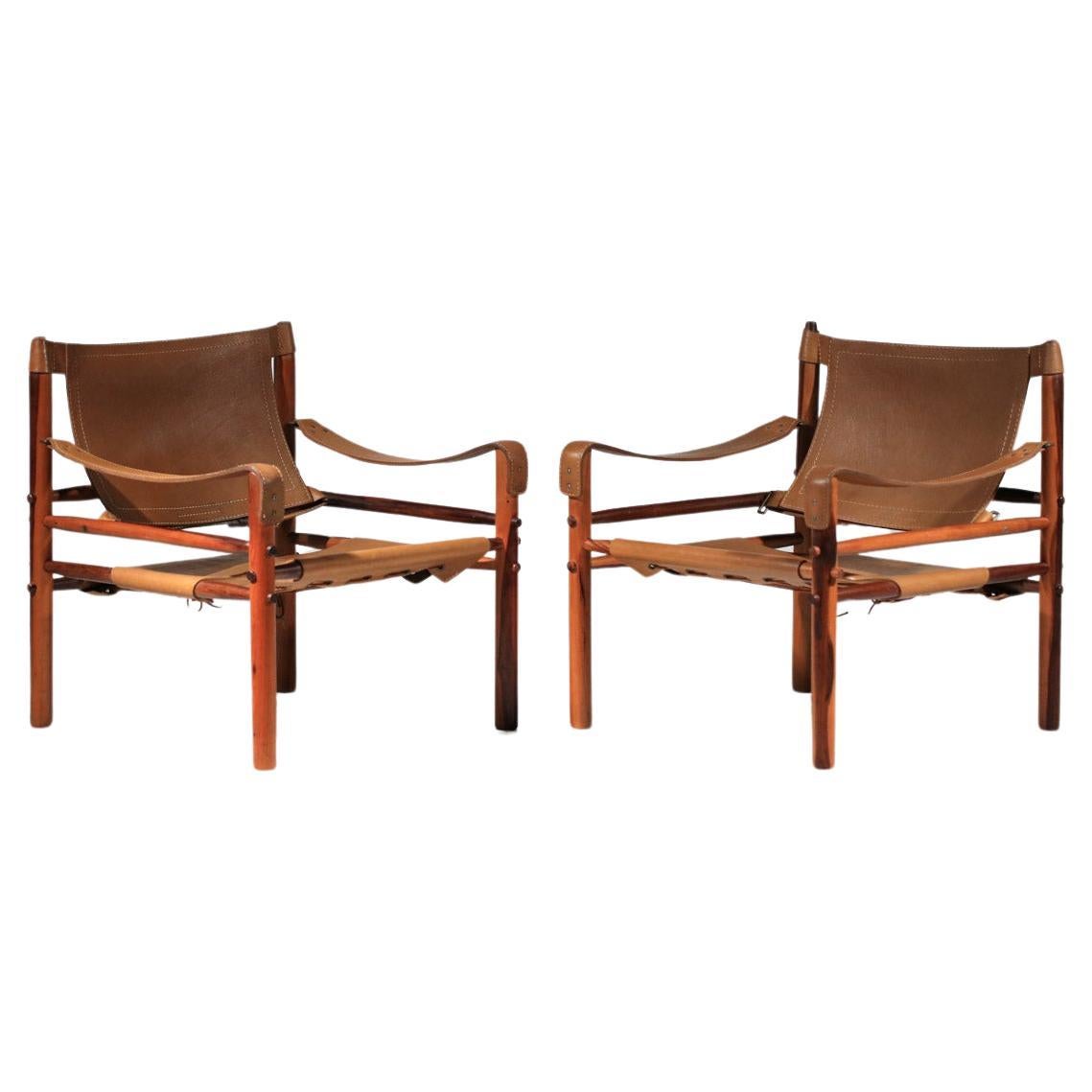 Pair of safari armchairs by Arne Norell in patinated leather and solid wood For Sale