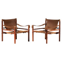 Pair of safari armchairs by Arne Norell in patinated leather and solid wood