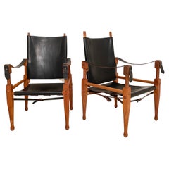Ein Paar Safari-Sessel von Wilhelm Kienzle aus schwarzem Leder und Eiche, 1950er Jahre