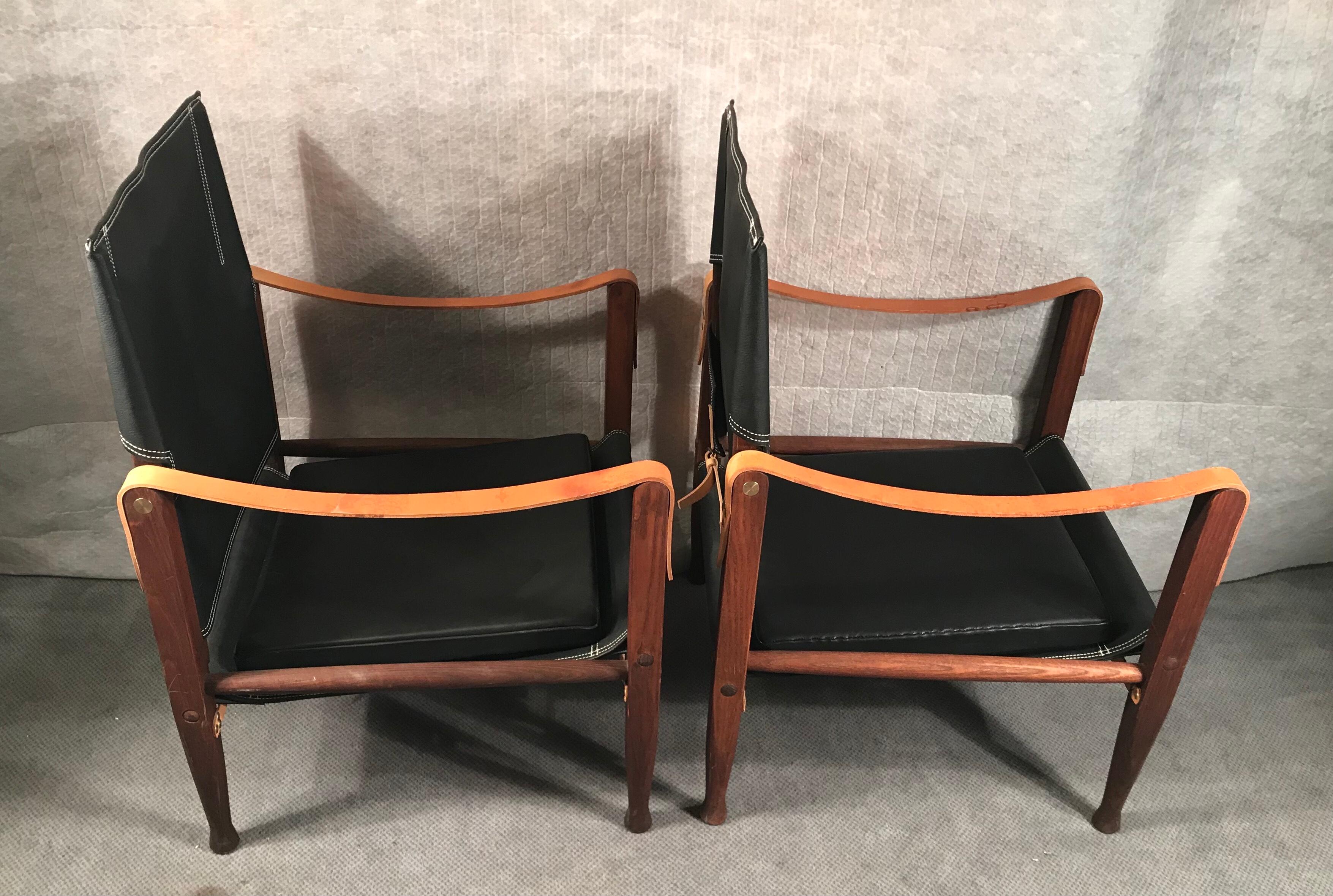 Pair of Safari chairs by Kaare Klint
The original design for the so called Safari chairs dates back to 1933.

The exposed teak frame uses the support of doweled rods, slung leather, and brass buckled straps. The backrest swivels for added