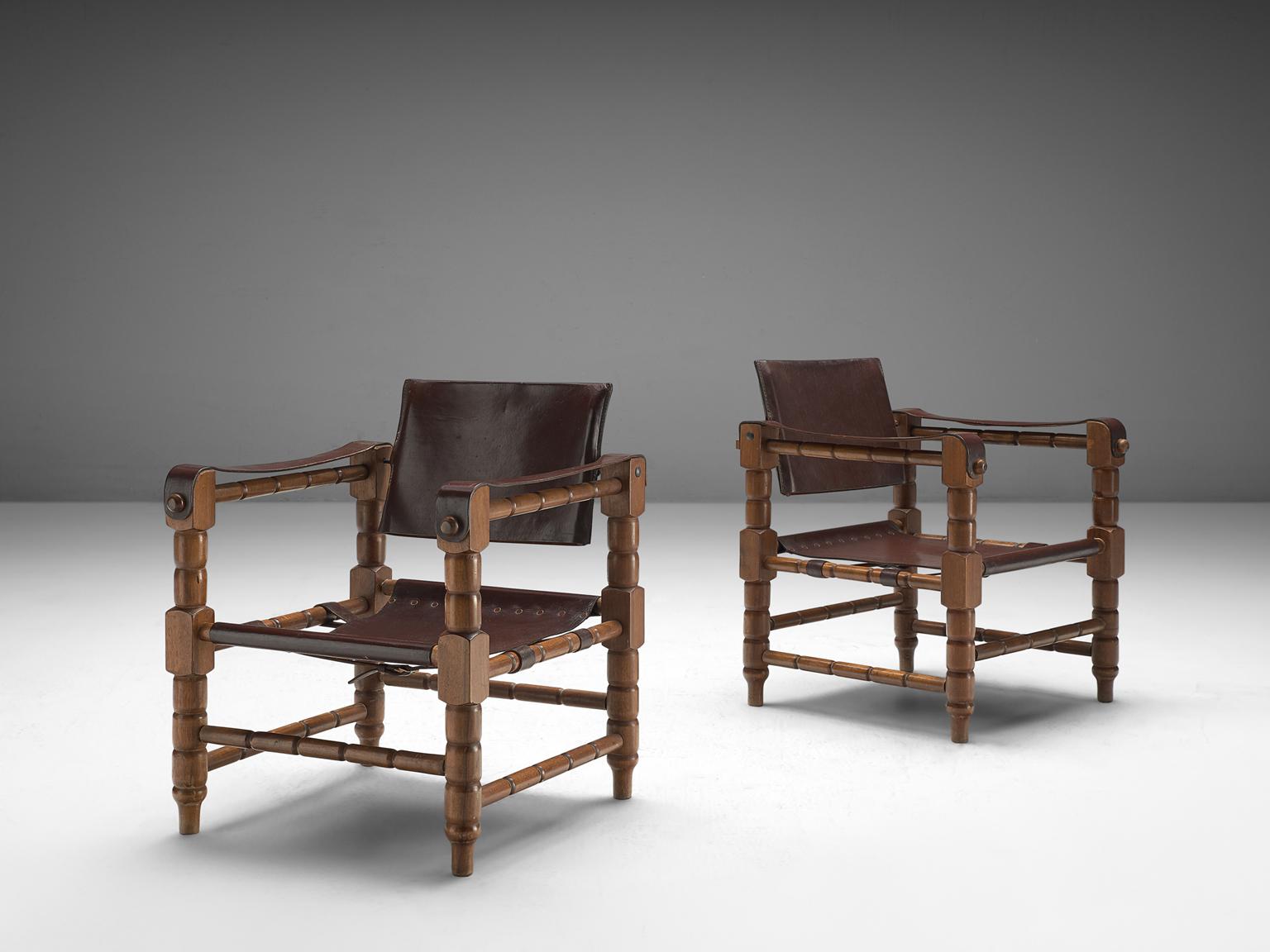 Safari chair, beech and leather, Europe, 1940s

Robust yet stately safari chairs with a rich patina. These chairs feature wonderfully carved wooden frames, with sculpted forms. The frame holds the leather straps that function as armrests and the
