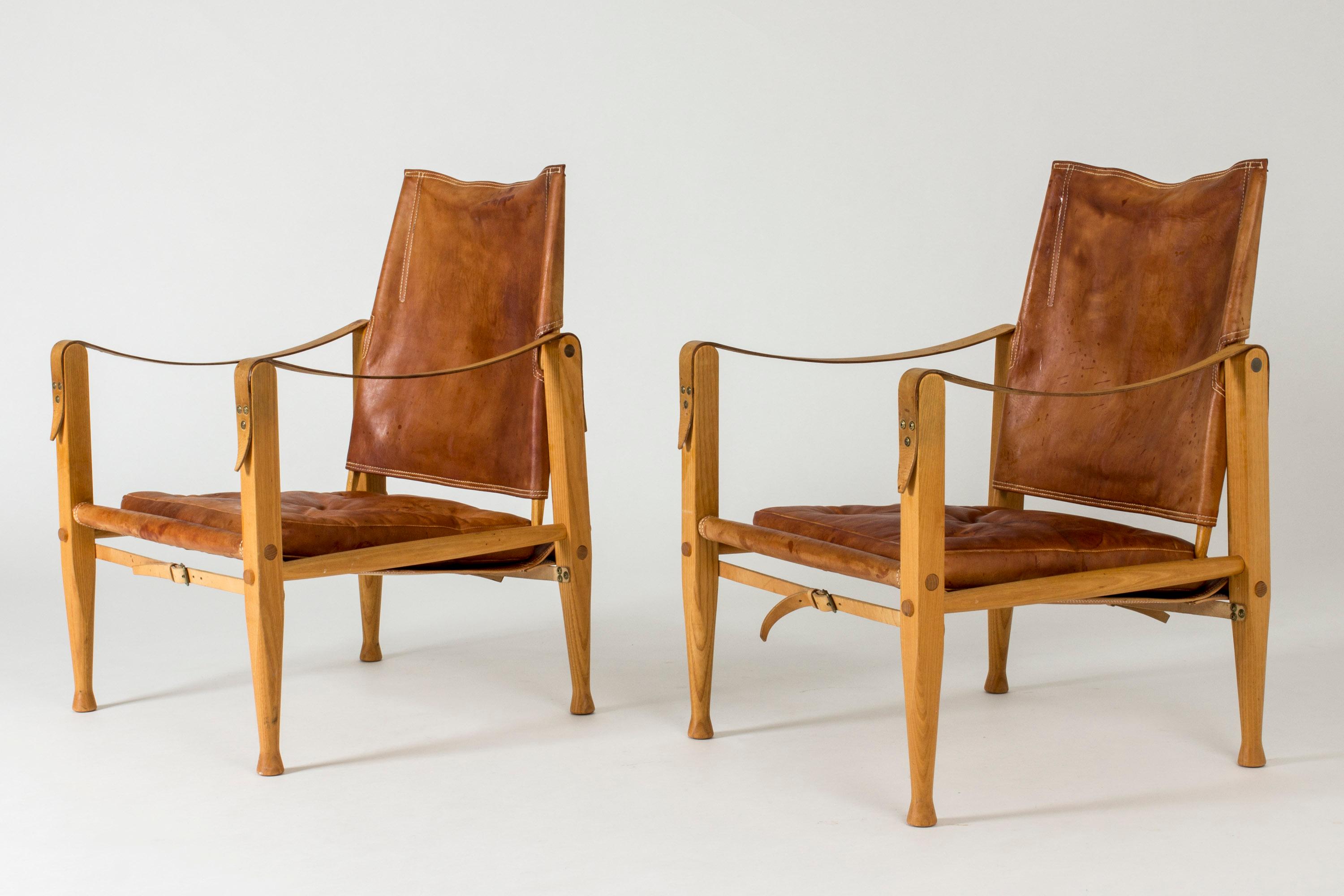 Pair of amazing “Safari” lounge chairs by Kaare Klint. Oak frame with nicely tapering legs, cognac leather with heavy patina. Very nice leather details.